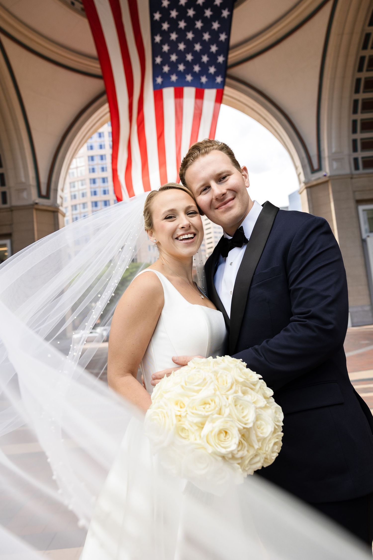 Bride and groom portraits with a flowing veil at Boston Harbor Hotel in Boston, Massachusetts, captured by Grand Photo by Karyna Oliinyk