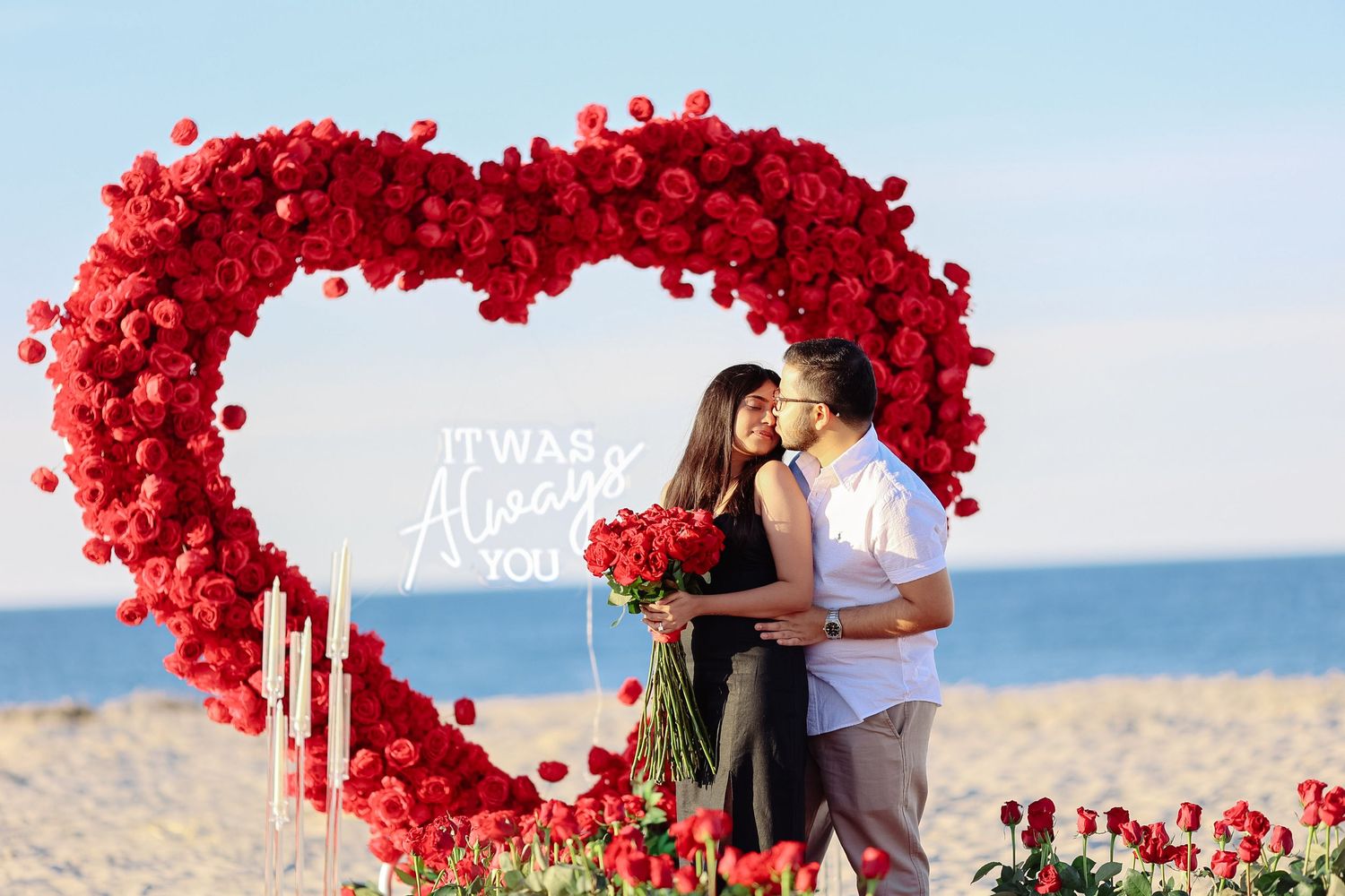 Surprise beach proposal session with a red heart arch in Boston Massachusetts, captured by Grand Photo, Karyna Oliinyk