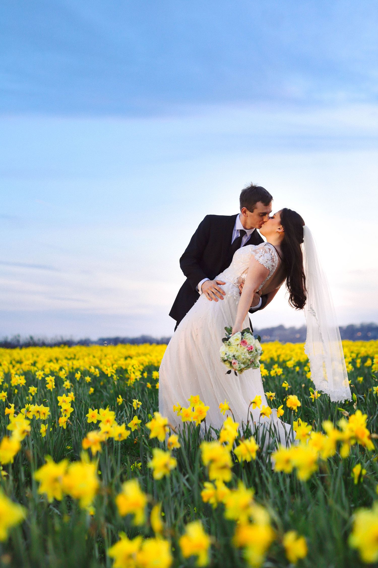 Bride and groom kissing in daffodil fields at Newport RI — Rhode Island wedding photographer Grand Photo Karyna Oliinyk