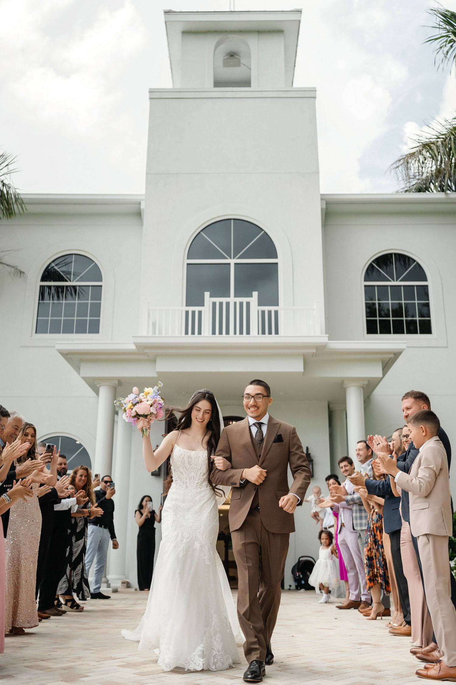Newlyweds exiting after the ceremony at Harborside Chapel in Safety Harbor, Florida — wedding photographer Grand Photo, Karyna Oliinyk