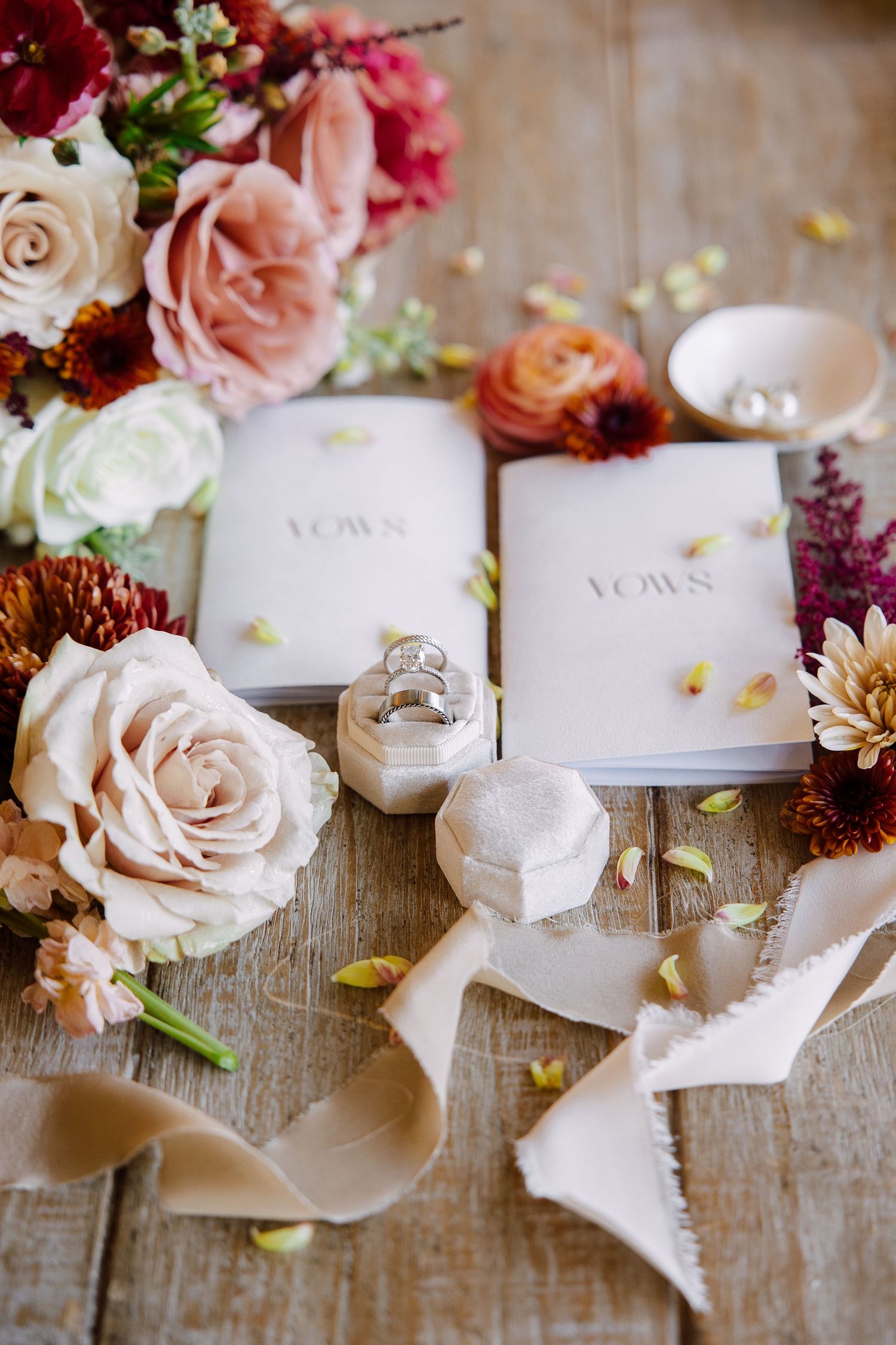 Colorful wedding flat lay featuring vow books at The Tampa Club in Tampa, Florida, captured by Grand Photo by Karyna Oliinyk
