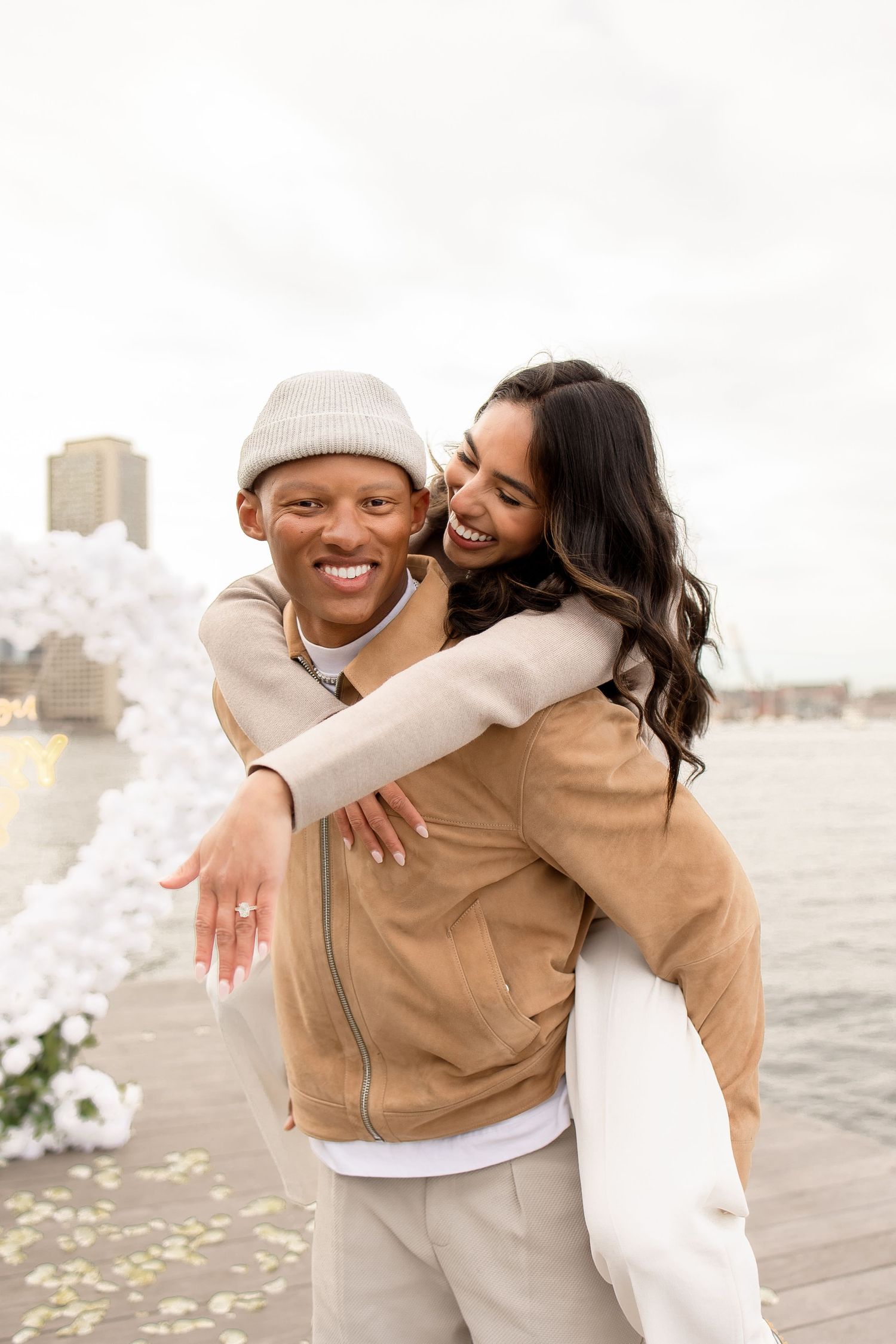 Surprise proposal session with a white heart arch in Seaport Boston Massachusetts, captured by Grand Photo, Karyna Oliinyk