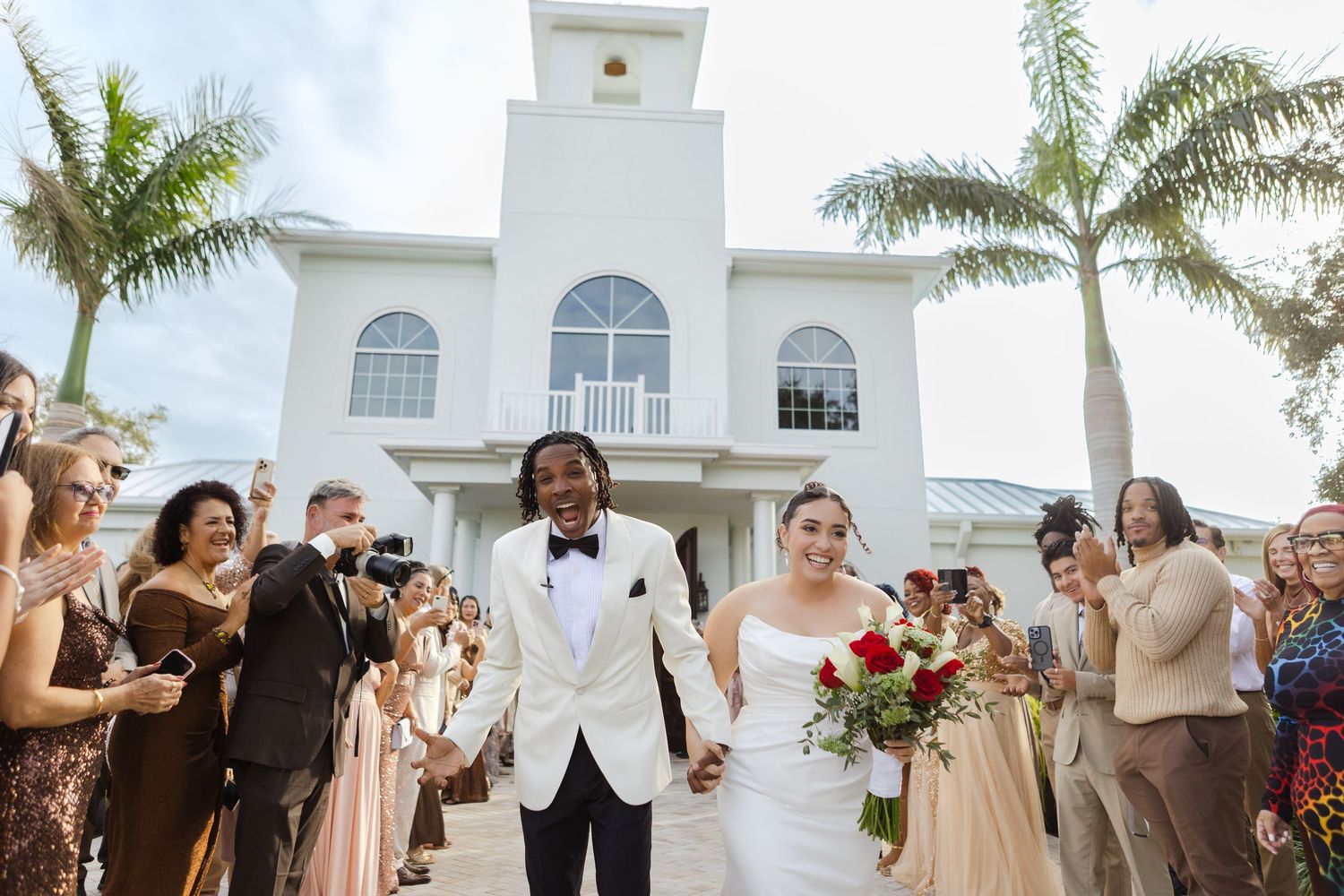 Newlyweds exiting the ceremony outside Harborside Chapel in Safety Harbor, Florida — wedding photographer Grand Photo, Karyna Oliinyk