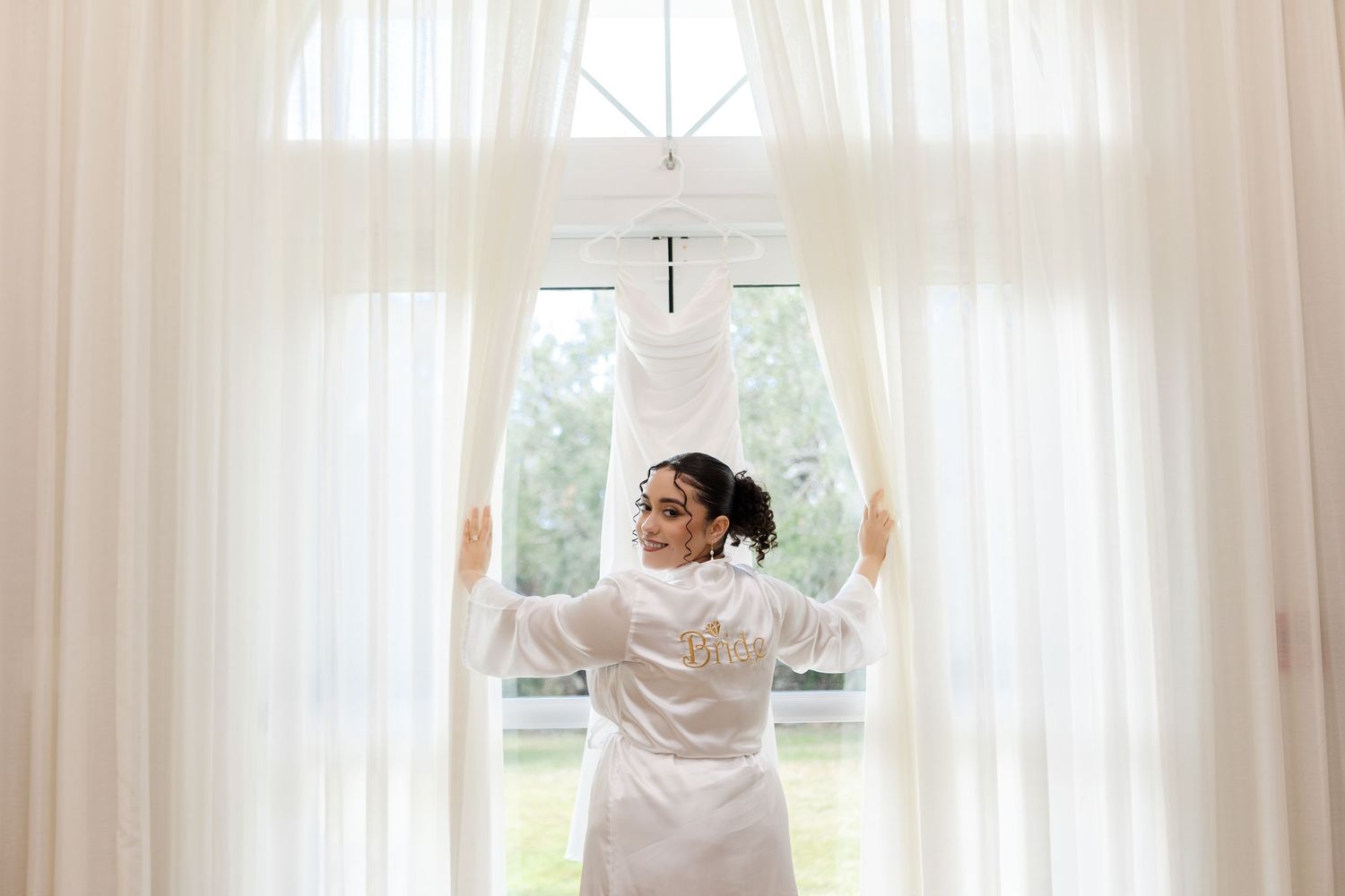 Bride admiring her wedding dress at Harborside Chapel in Safety Harbor, Florida — wedding photographer Grand Photo, Karyna Oliinyk