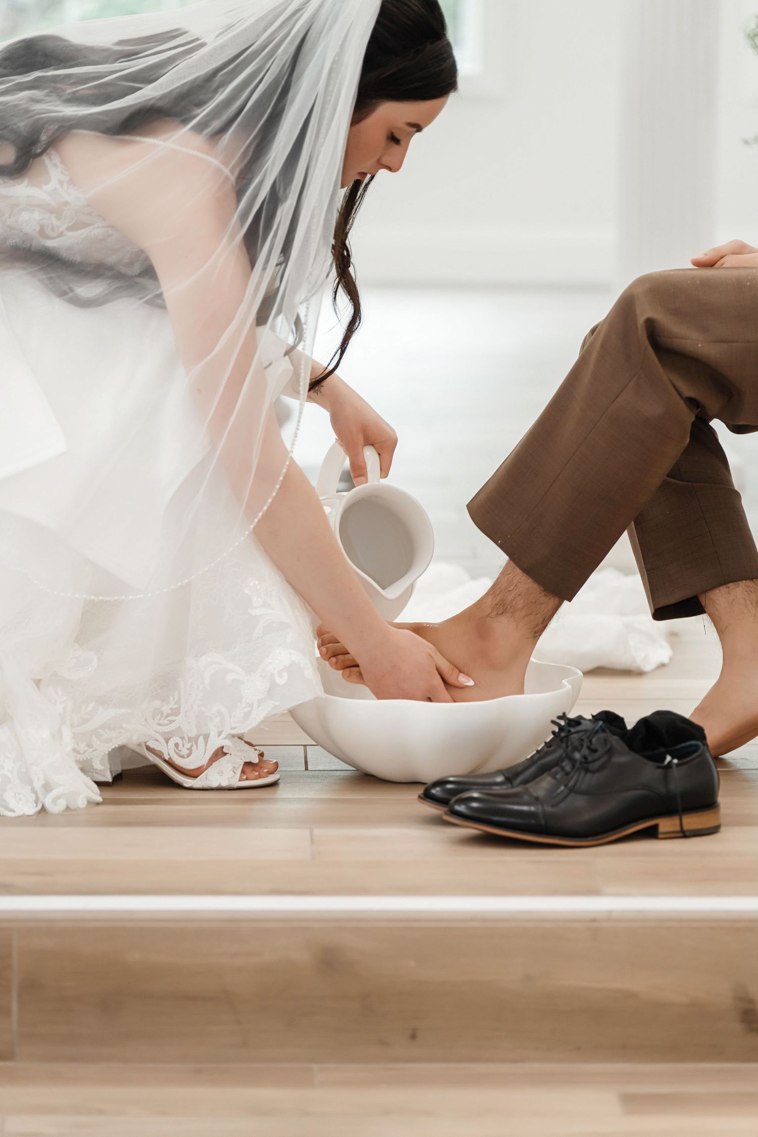 Foot-washing ceremony during the wedding at Harborside Chapel in Safety Harbor, Florida — wedding photographer Grand Photo, Karyna Oliinyk