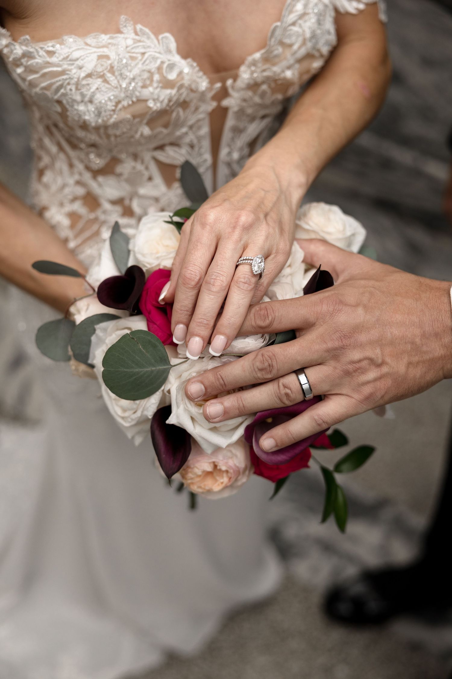 Newlyweds displaying wedding rings over bridal bouquet at Le Méridien Tampa, Florida, captured by Grand Photo by Karyna Oliinyk