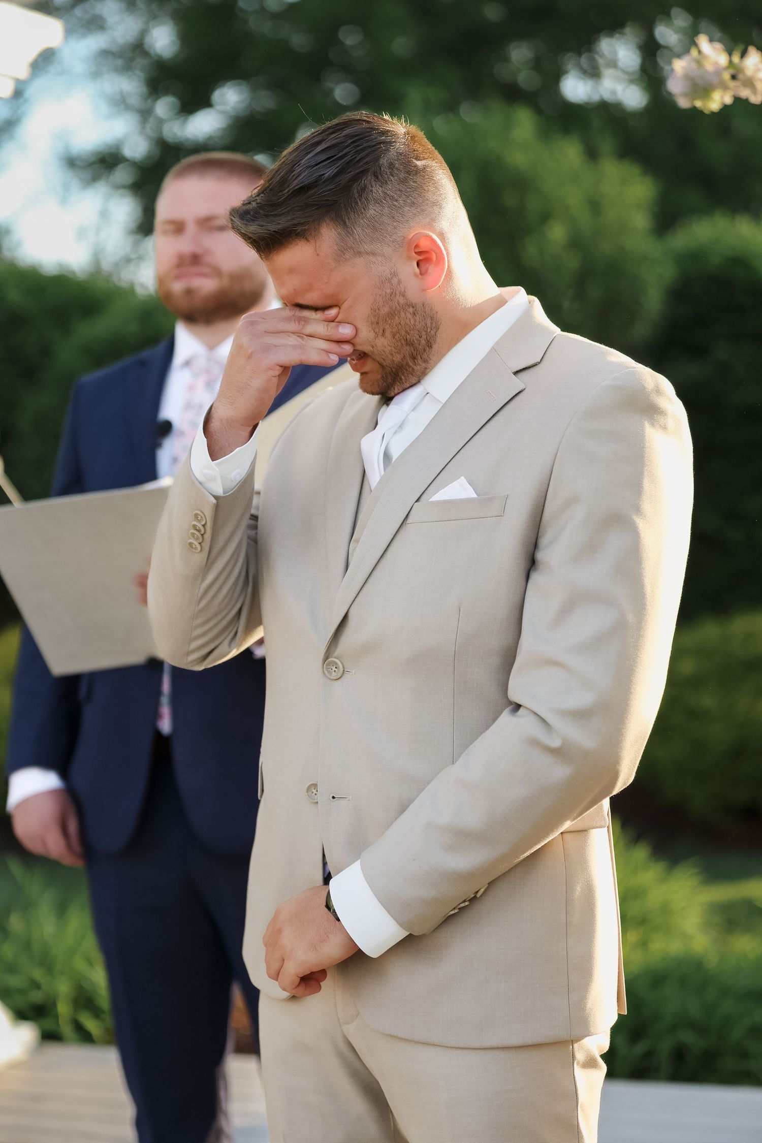Emotional groom wiping tears at outdoor ceremony at Selby Gardens Sarasota FL, wedding photographer Grand Photo Karyna Oliinyk