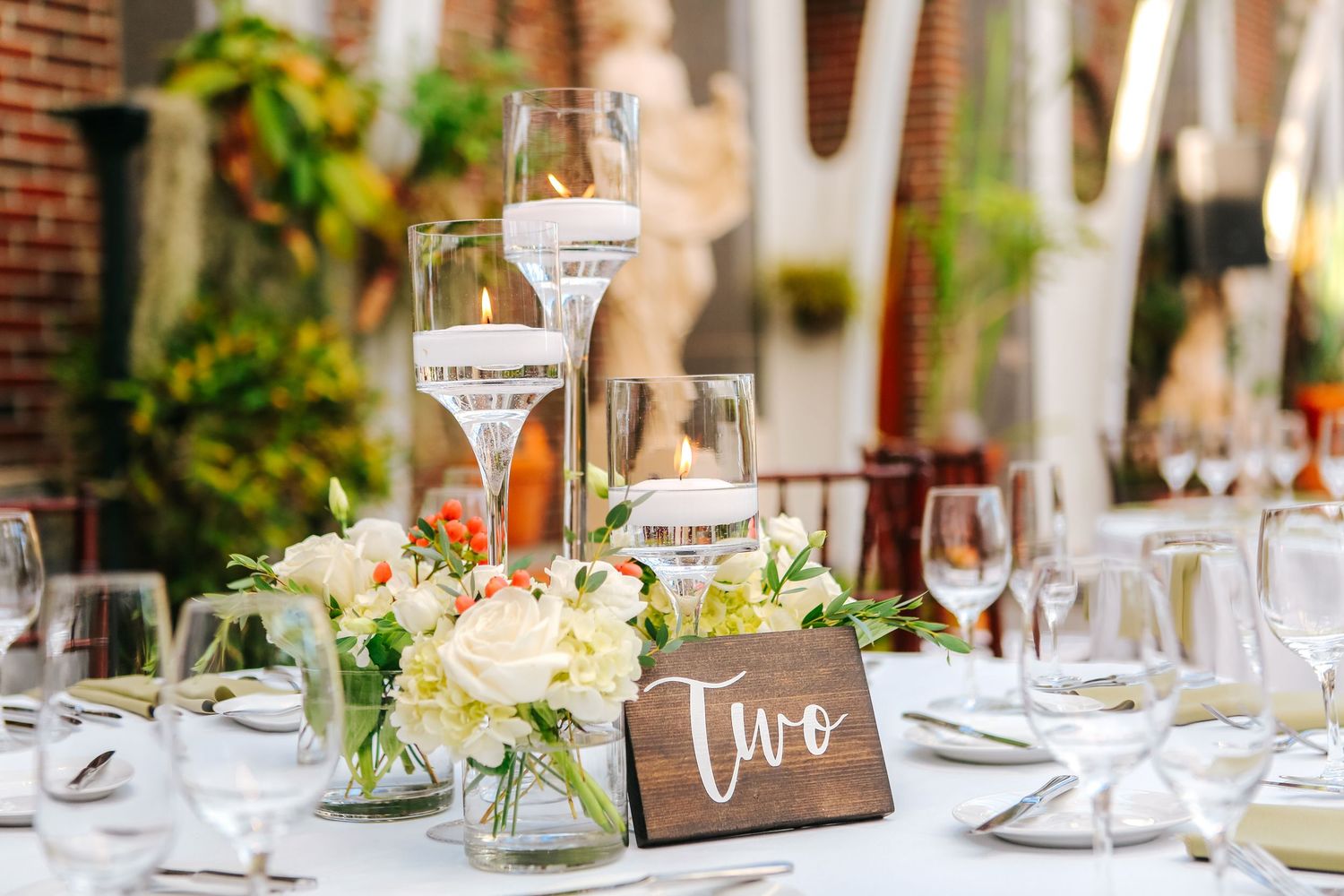 Elegant wedding table centerpiece with white roses and candles at Hyde House Public Studio Tampa FL, wedding photographer Grand Photo