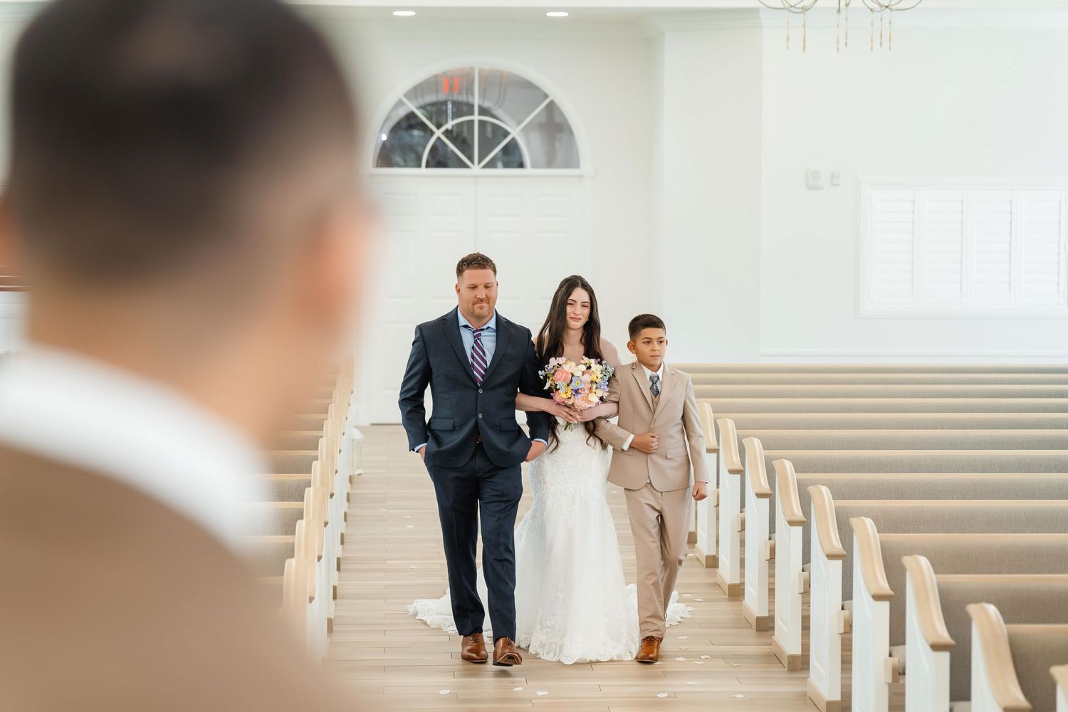 Bride walking down the aisle crying at Harborside Chapel in Safety Harbor, Florida — wedding photographer Grand Photo, Karyna Oliinyk