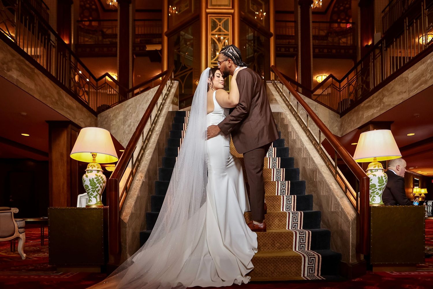 First look of bride and groom on stairs at Hilton Providence in Providence, Rhode Island, captured by Grand Photo by Karyna Oliinyk