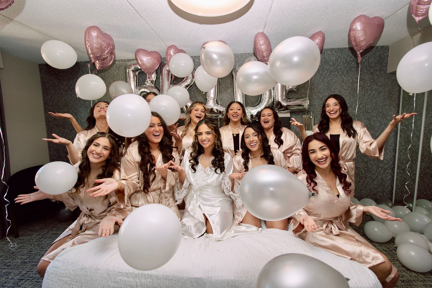Bride and bridesmaids in satin robes getting ready at The Tampa Club Tampa FL, wedding photographer Grand Photo Karyna Oliinyk