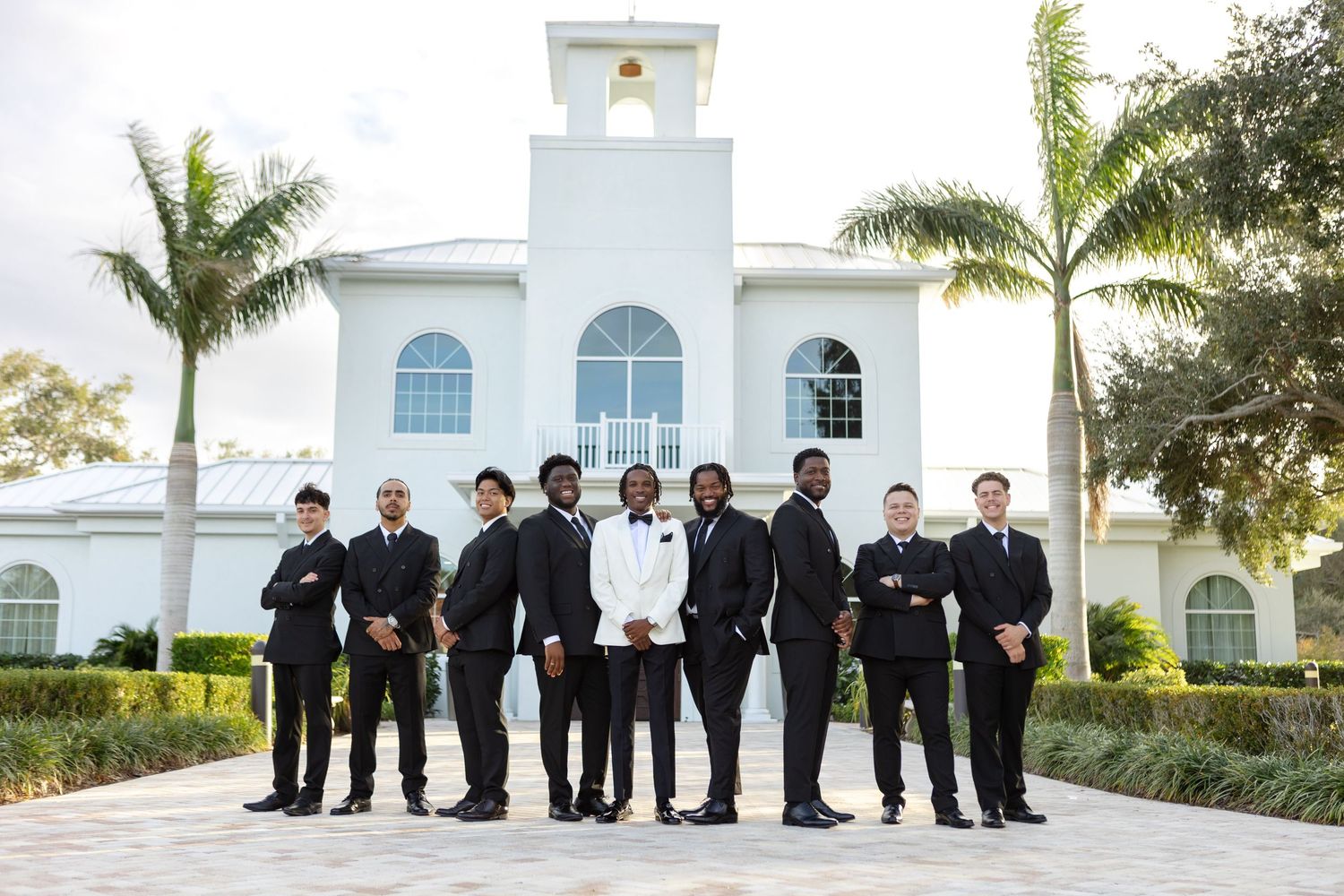 Groom in white tux with groomsmen at Harborside Chapel, Safety Harbor FL, by Grand Photo FL wedding photographer Karyna Oliinyk