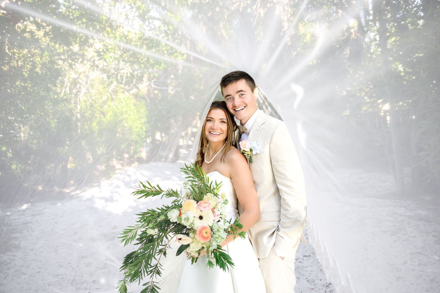 Bride and groom under the veil at Sunken Gardens in St. Petersburg, Florida, captured by Grand Photo by Karyna Oliinyk