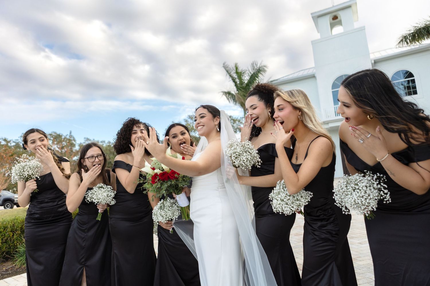 Bride and bridesmaids enjoying a joyful moment at Harborside Chapel in Safety Harbor — wedding photographer Grand Photo, Karyna Oliinyk