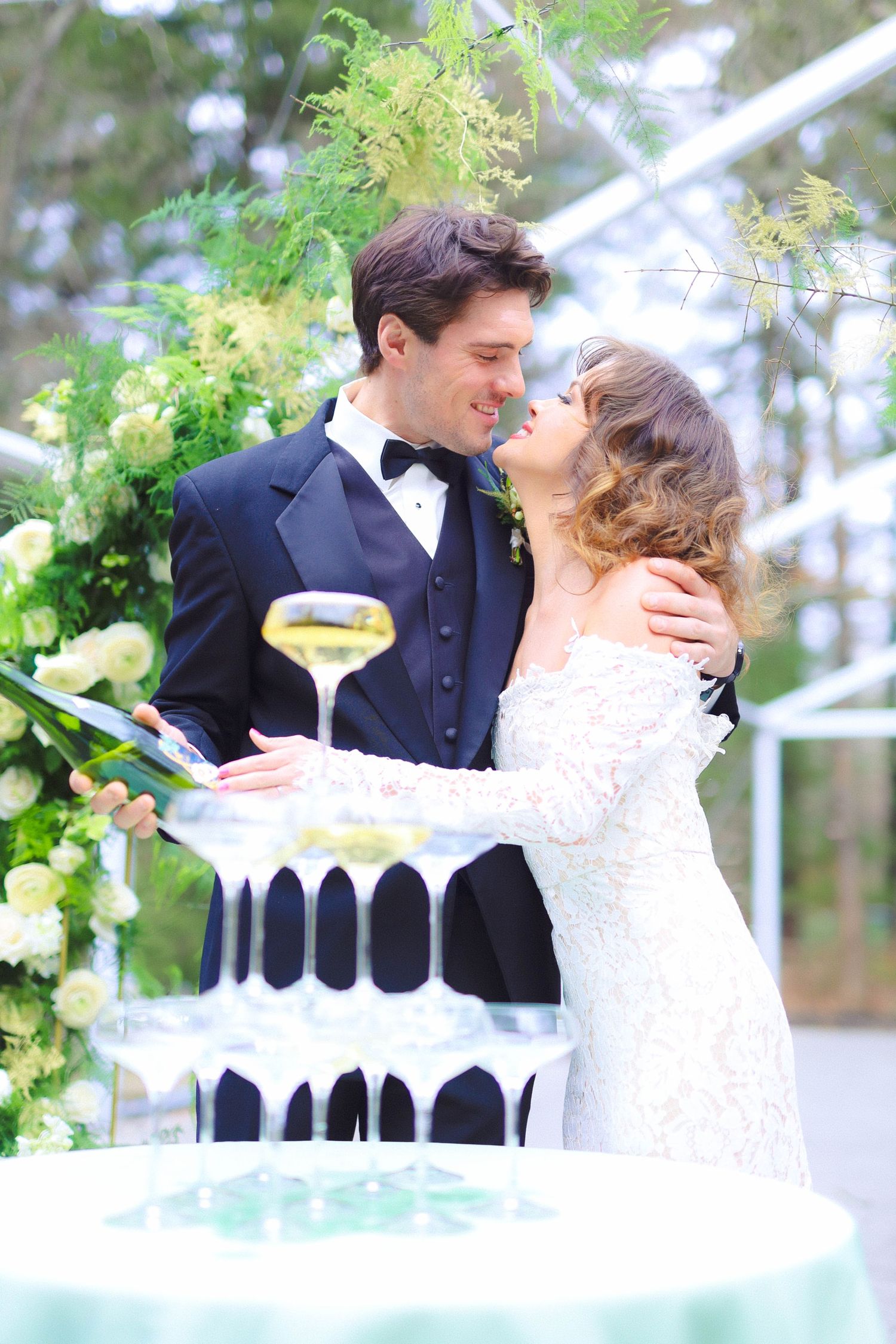 Bride and groom pour champagne tower at The Vinoy Resort & Golf Club in St. Petersburg, Florida, captured by Grand Photo by Karyna Oliinyk