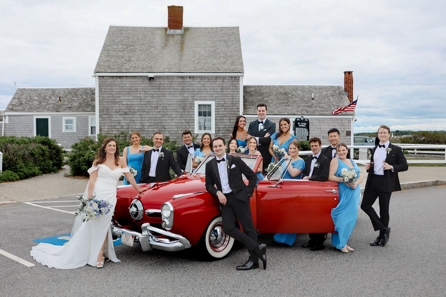 Wedding party with classic red vintage convertible car at Scituate Lighthouse in Scituate, Massachusetts, captured by Grand Photo by Karyna
