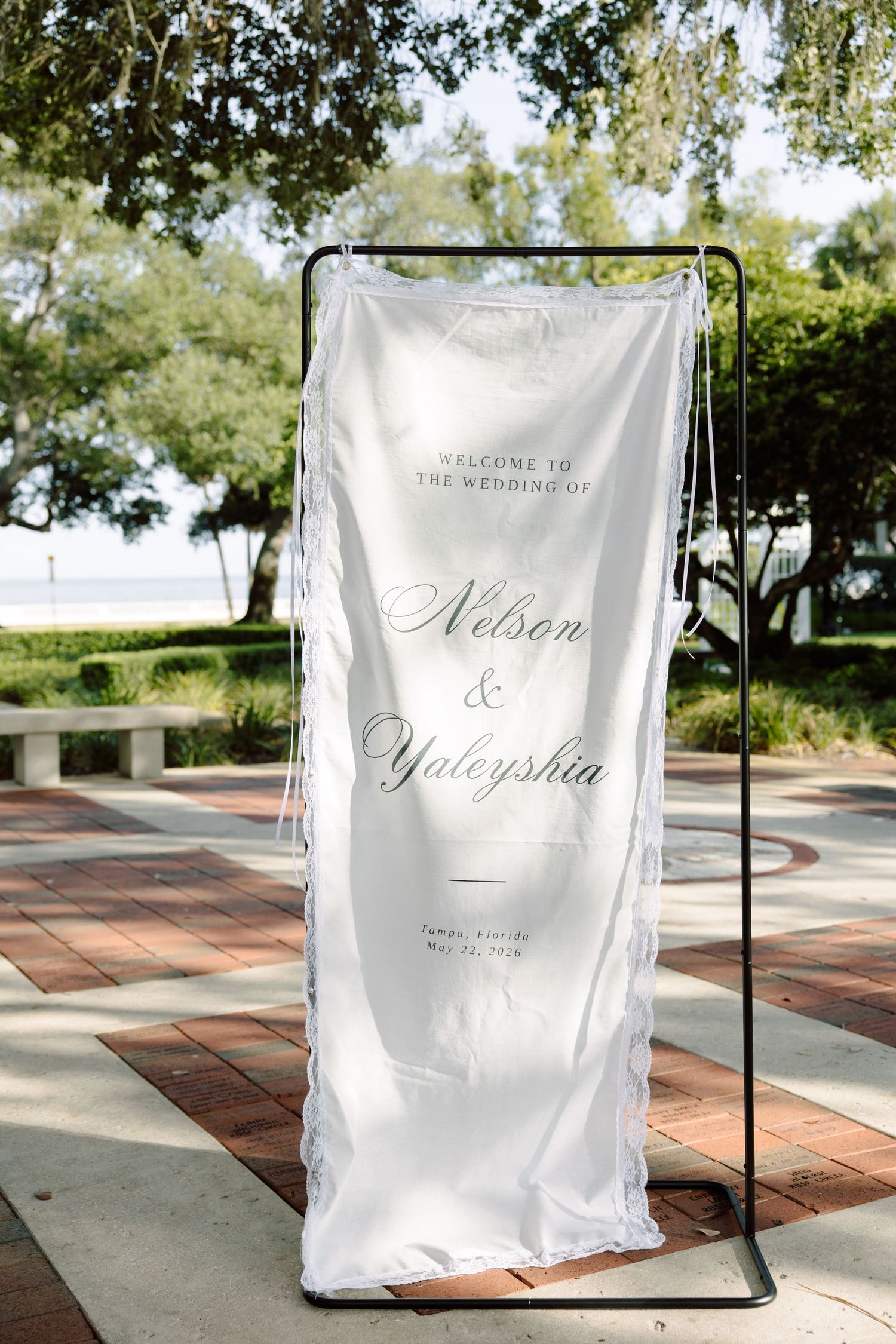 Elegant outdoor wedding welcome banner at Tampa Garden Club, Florida, captured by Grand Photo by Karyna Oliinyk