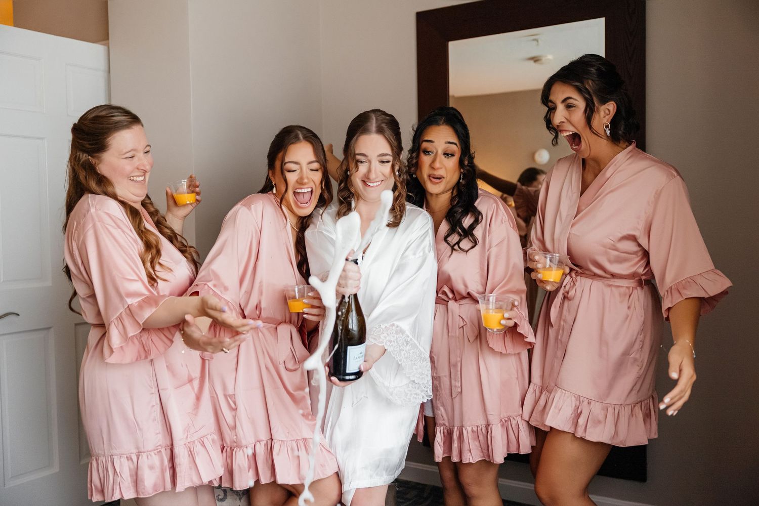Bride and bridesmaids champagne toast at Nantasket Beach Resort in Hull, Massachusetts, captured by Grand Photo by Karyna Oliinyk