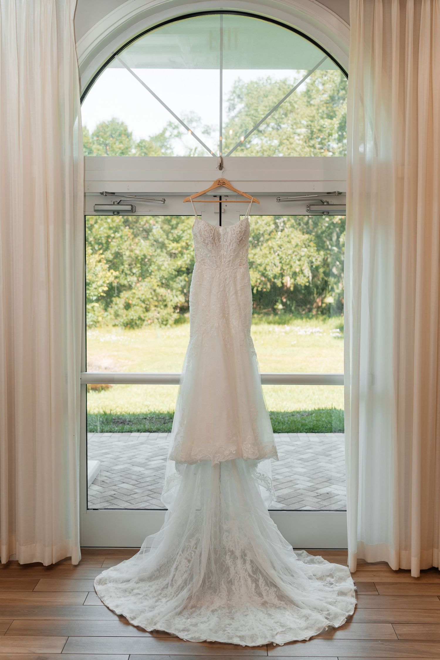 Elegant wedding dress in a getting-ready suite at Harborside Chapel in Safety Harbor — wedding photographer Grand Photo, Karyna Oliinyk