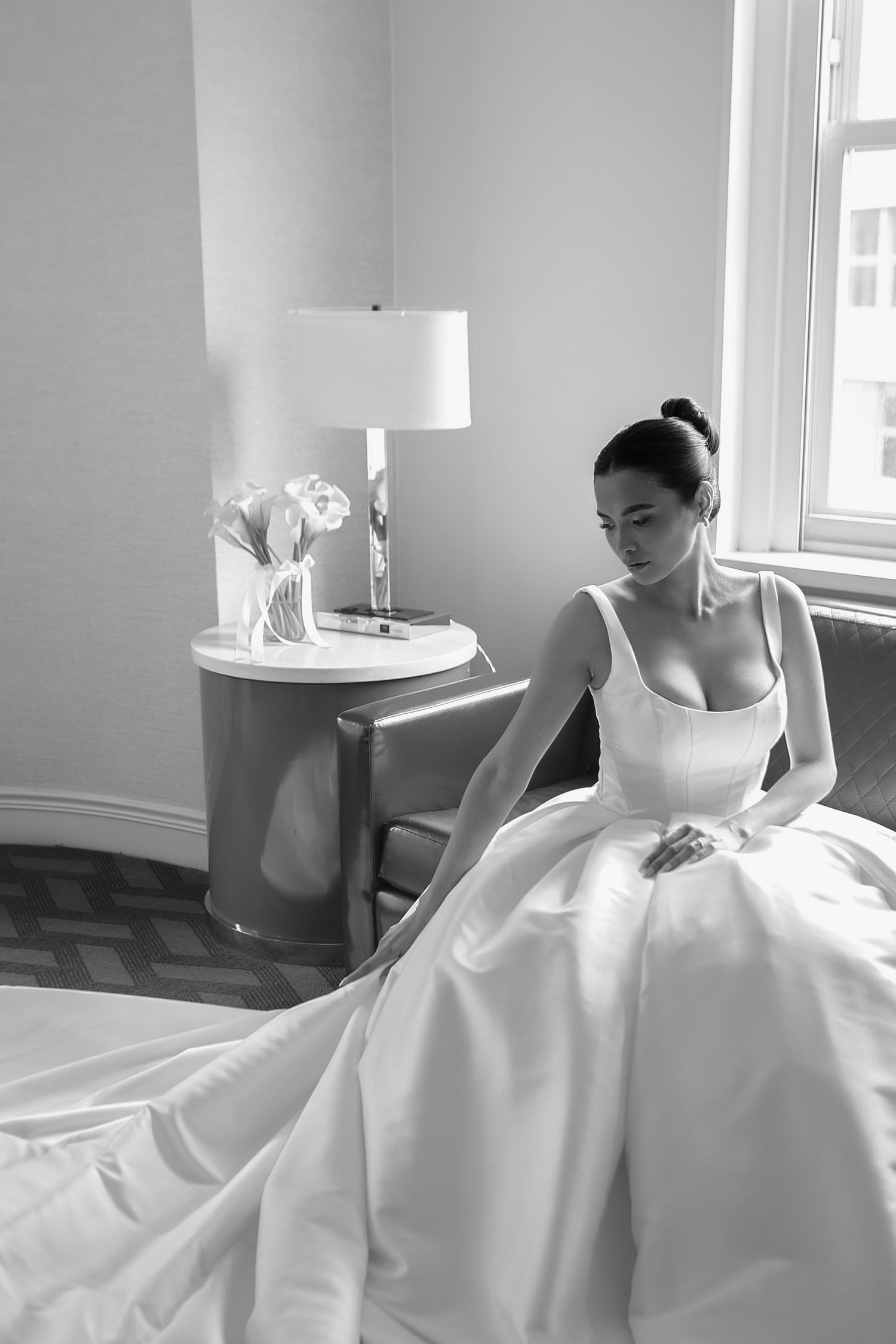 Elegant black and white portrait of bride in a ball gown in a hotel room at The Tampa EDITION in Tampa, Florida, captured by Grand Photo