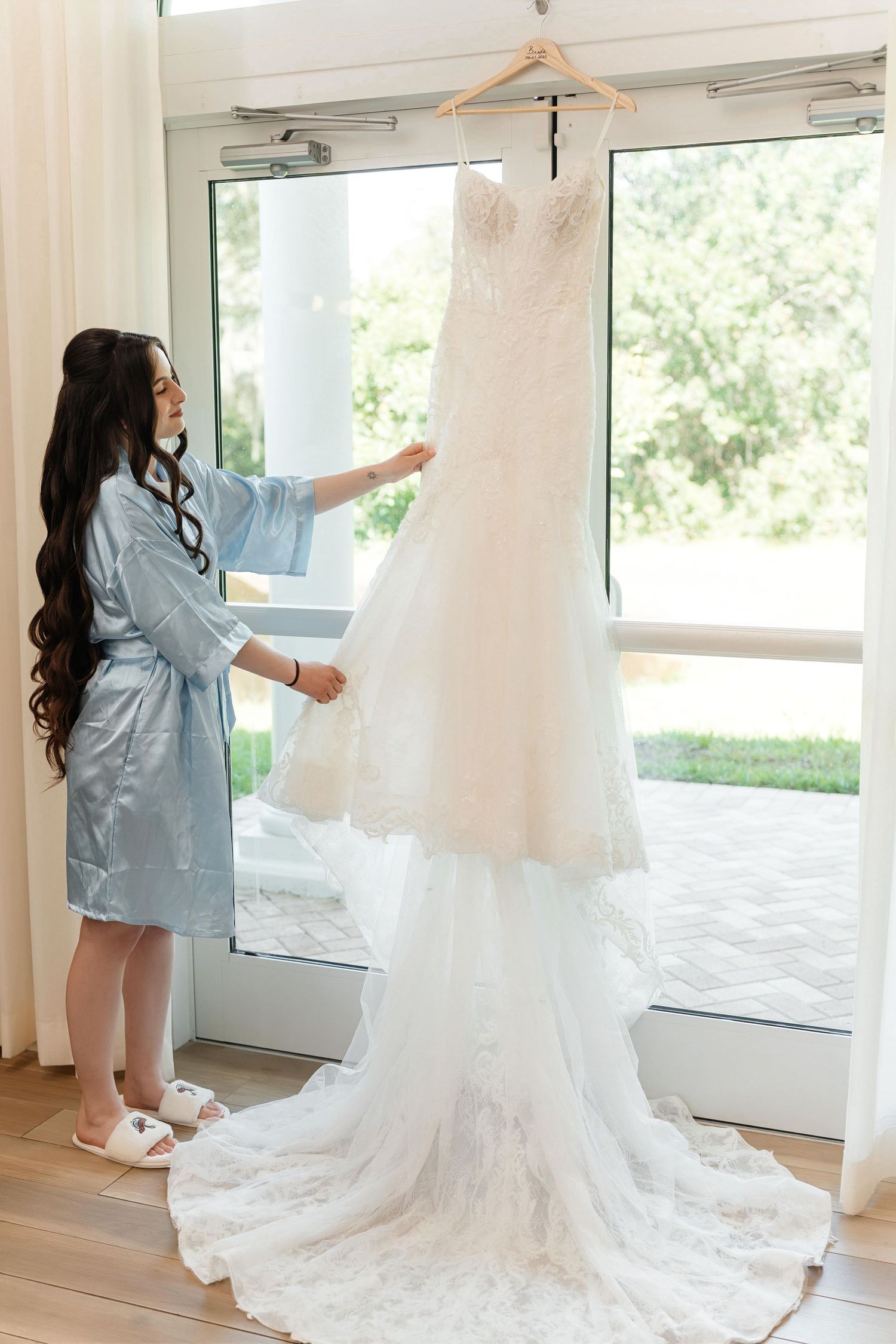 Bride admiring her wedding dress at Harborside Chapel in Safety Harbor — wedding photographer Grand Photo, Karyna Oliinyk