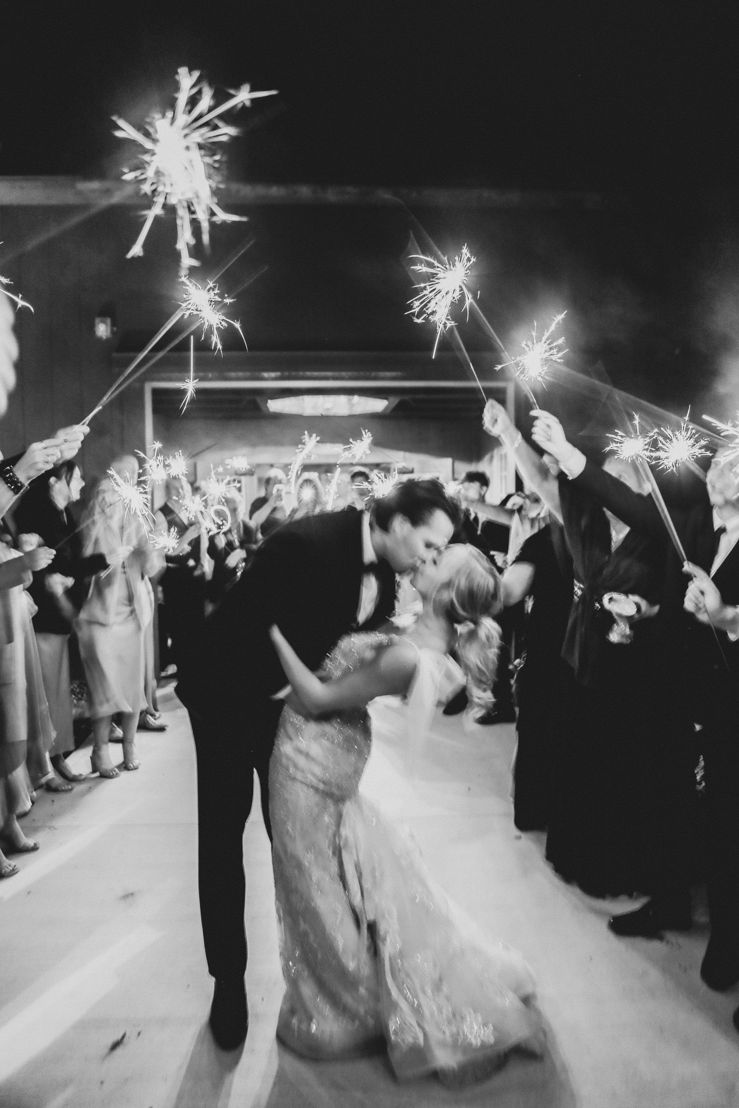Bride and groom share a kiss during a sparkler send-off at The Ringling in Sarasota, Florida wedding photographer Grand Photo Karyna Oliinyk