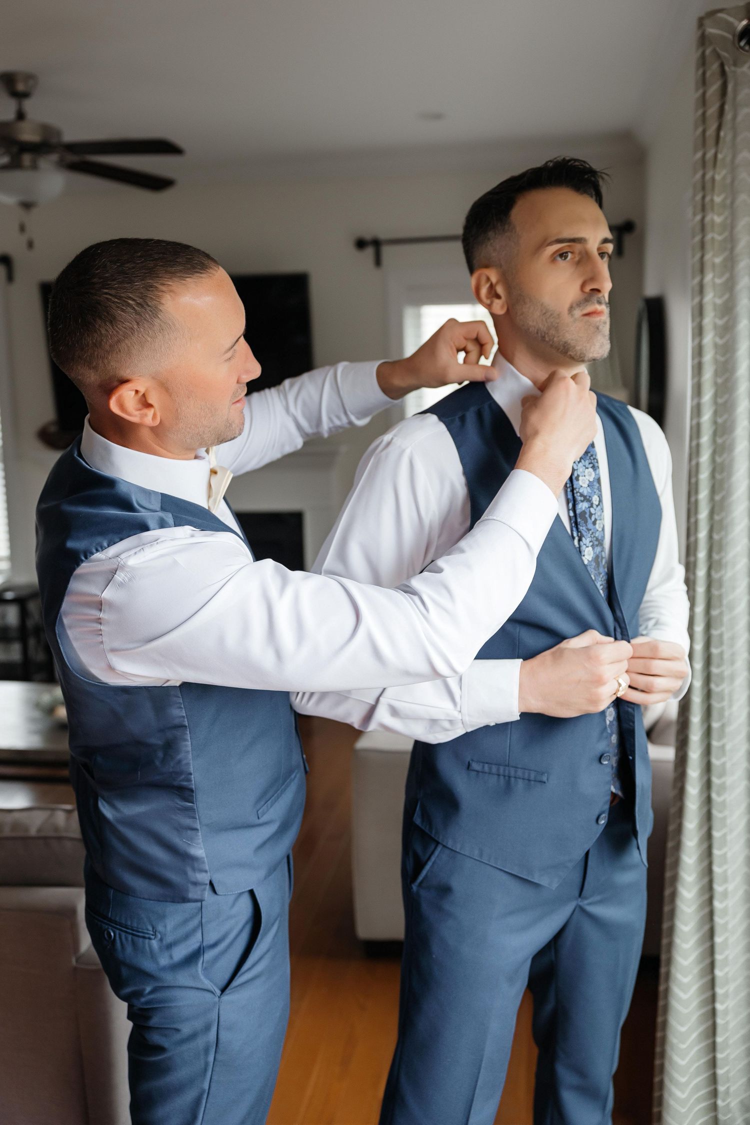 Best man helps groom get ready before ceremony at The Tampa EDITION in Tampa, Florida, captured by Grand Photo by Karyna Oliinyk