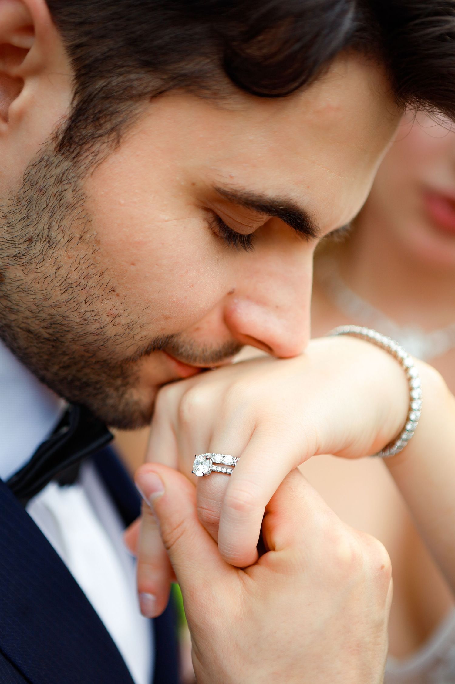 Groom kisses bride’s hand at Villa Madera Ballroom in Bridgewater, Massachusetts, captured by Grand Photo by Karyna Oliinyk