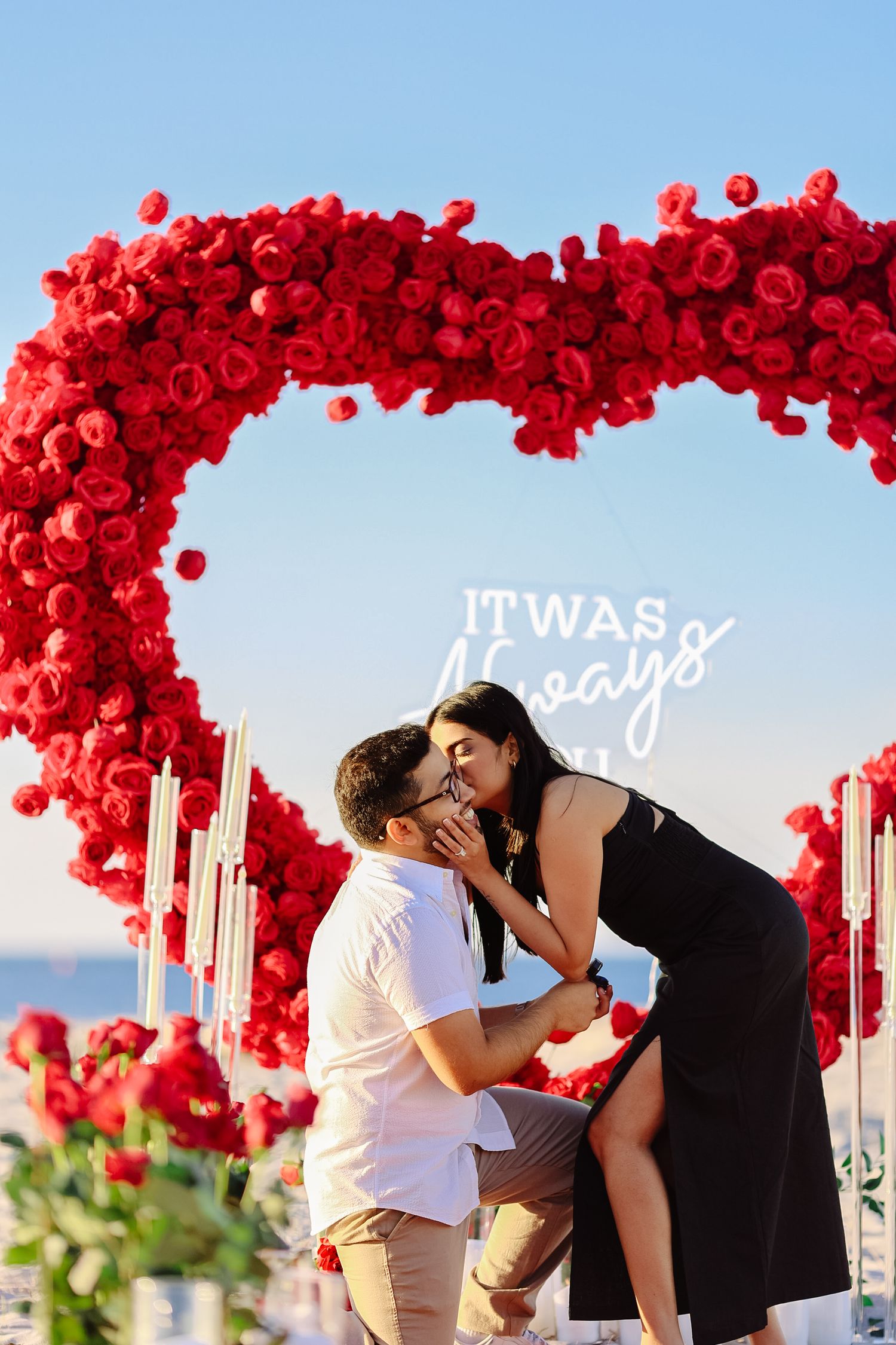 Surprise sunset beach proposal session with a red heart arch in Boston Massachusetts, captured by Grand Photo, Karyna Oliinyk