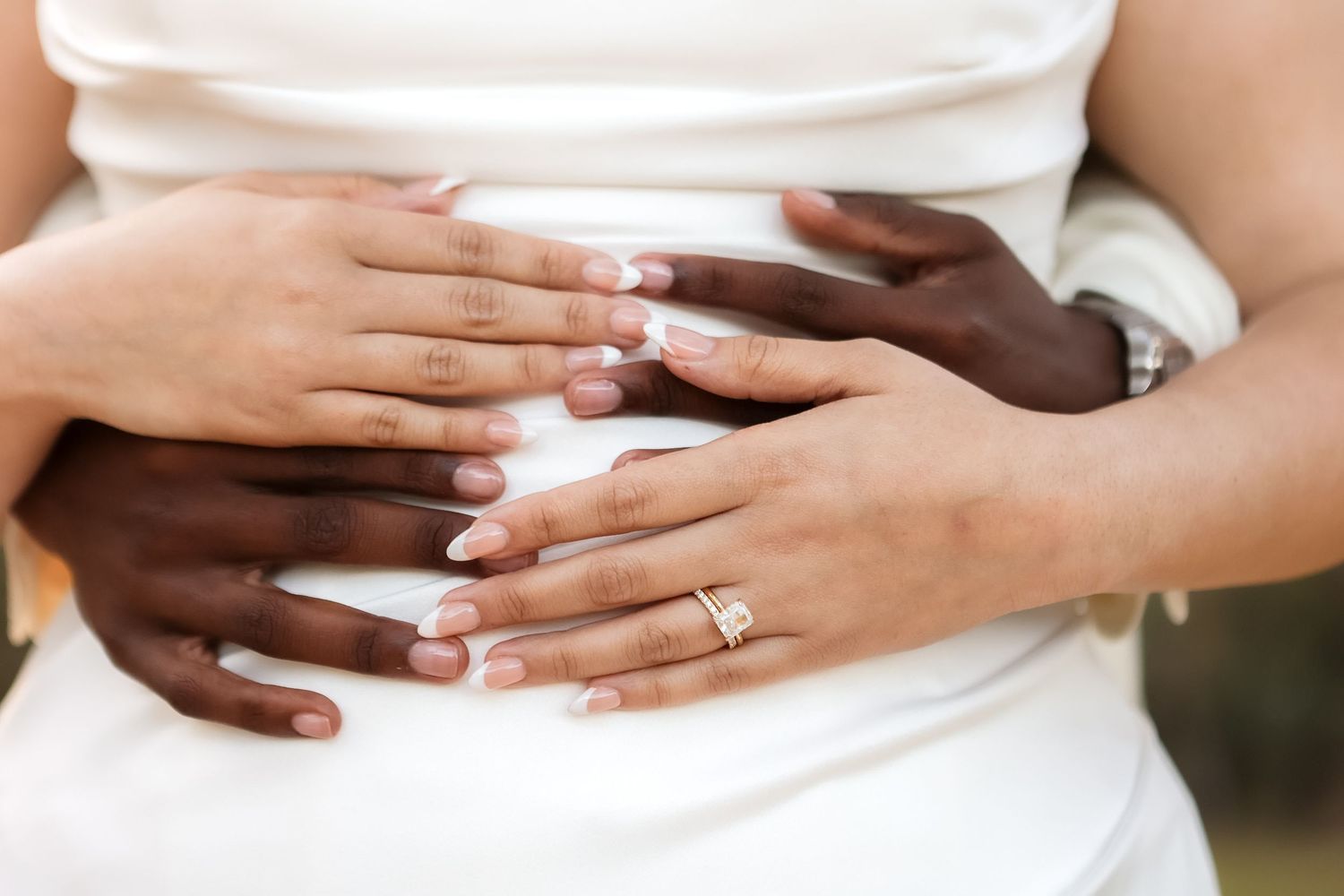 Interracial couple’s hands with wedding bands at Harborside Chapel in Safety Harbor — wedding photographer Grand Photo, Karyna Oliinyk