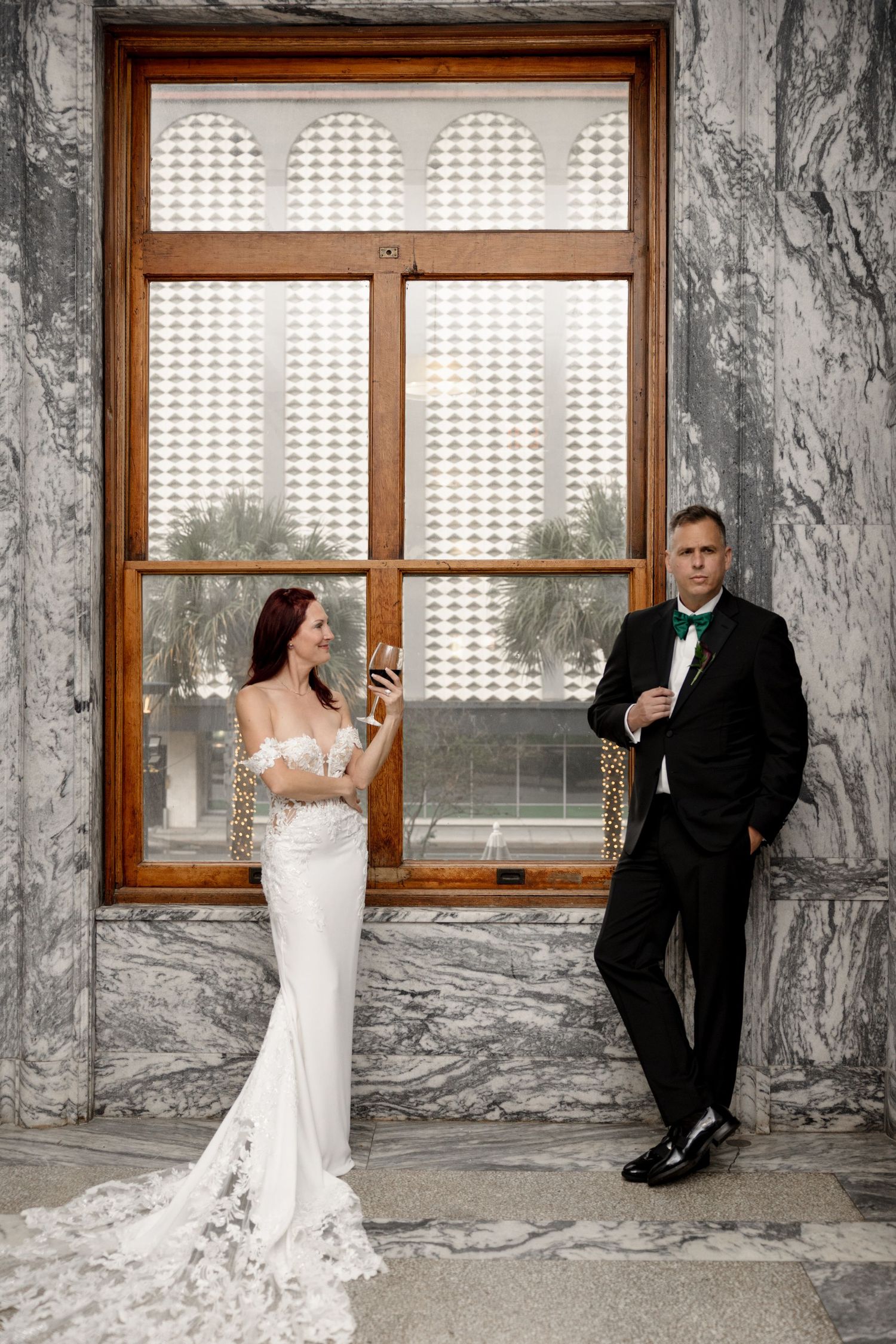 Bride and groom after the ceremony in front of the window at Le Méridien Tampa, Florida, captured by Grand Photo by Karyna Oliinyk