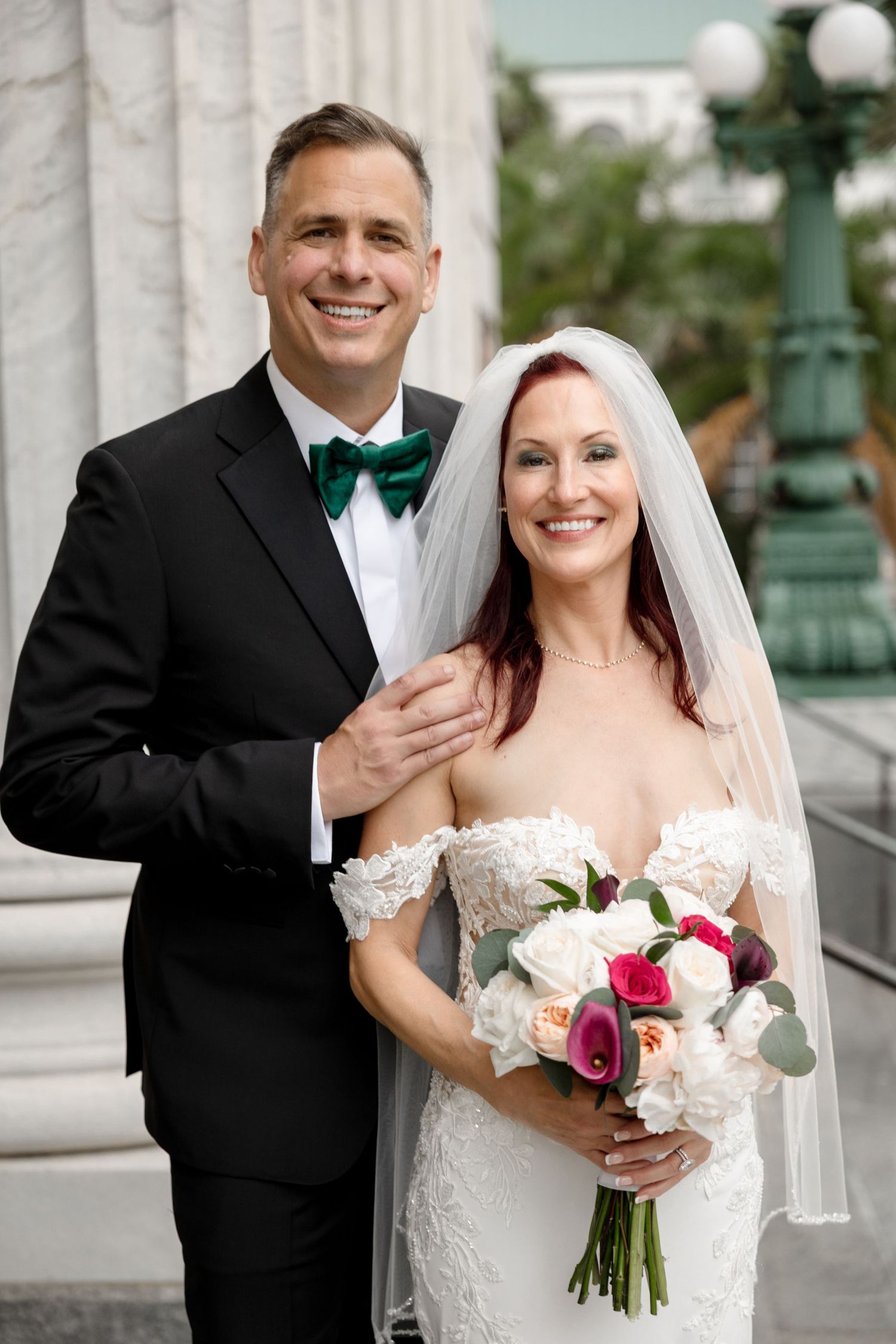 Smiling bride and groom pose outdoors at Le Méridien Tampa, Florida, captured by Grand Photo by Karyna Oliinyk