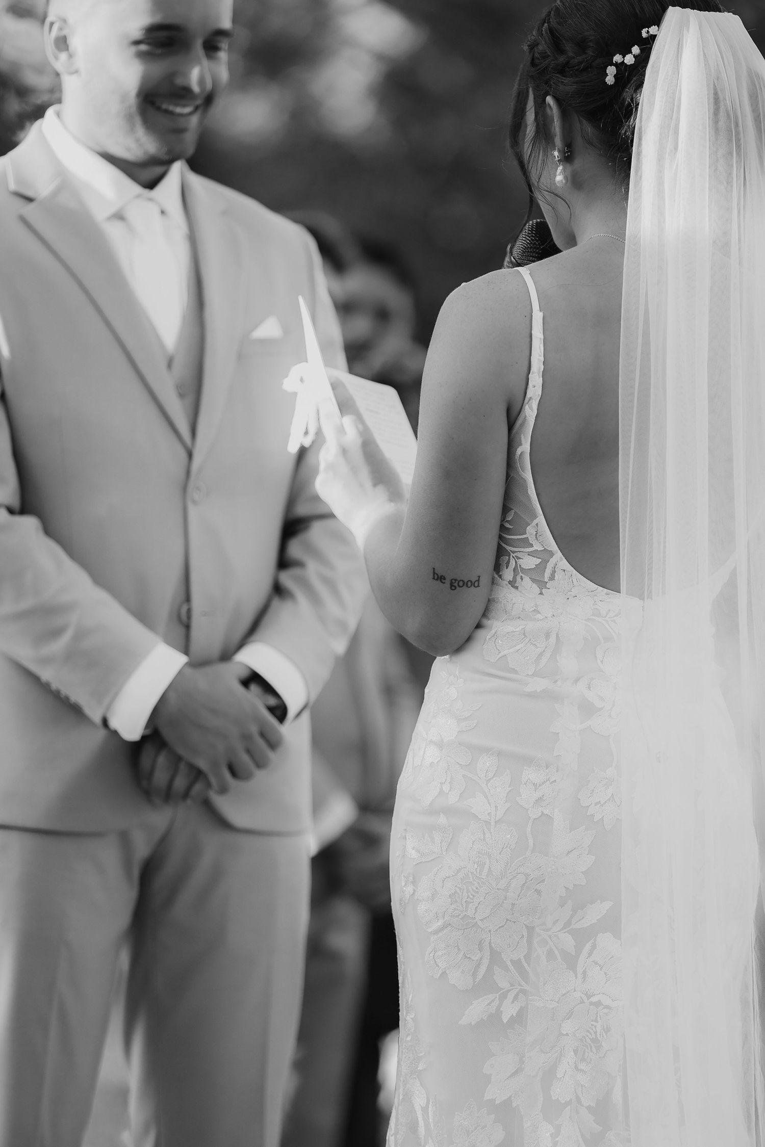 Bride reading vows to groom at outdoor wedding ceremony at Danversport in Danvers, Massachusetts, captured by Grand Photo by Karyna Oliinyk