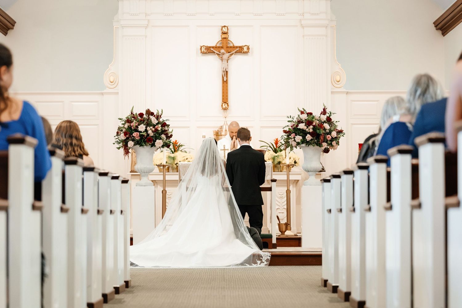 Bride and groom exchange vows at Christ the King Catholic Church South Tampa FL, wedding photographer Grand Photo Karyna Oliinyk
