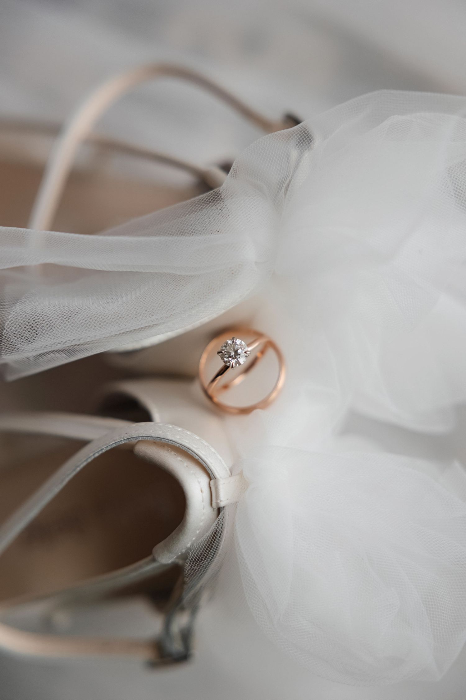 Engagement ring and gold wedding band on bridal heels at Harborside Chapel in Safety Harbor, Florida, captured by Grand Photo