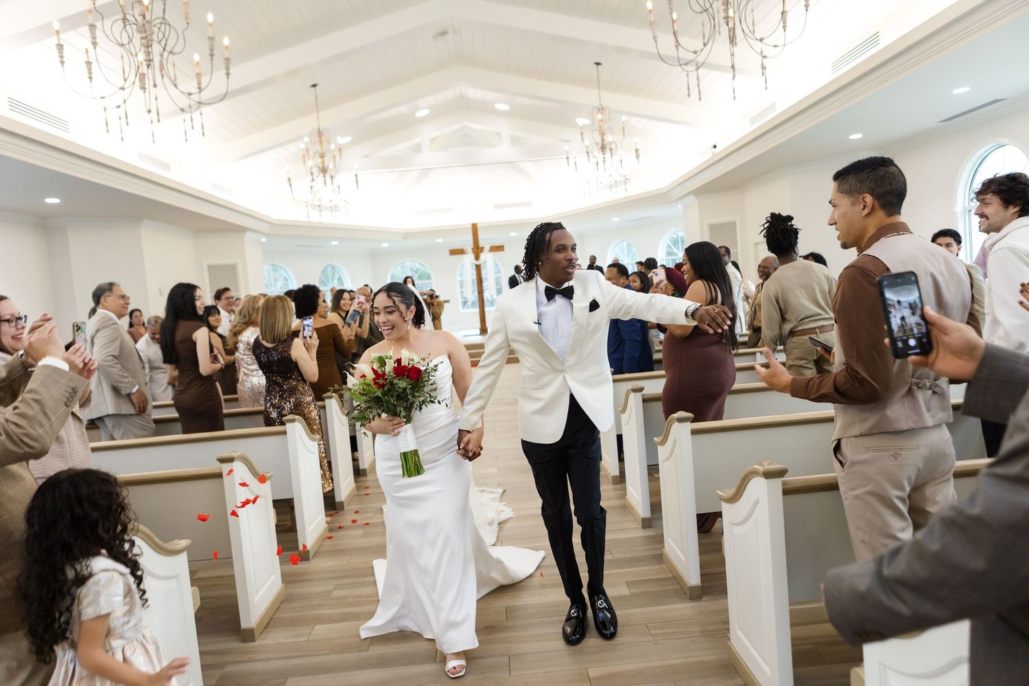Newlyweds walking down the aisle after the ceremony at Harborside Chapel in Safety Harbor — wedding photographer Grand Photo, Karyna Oliinyk