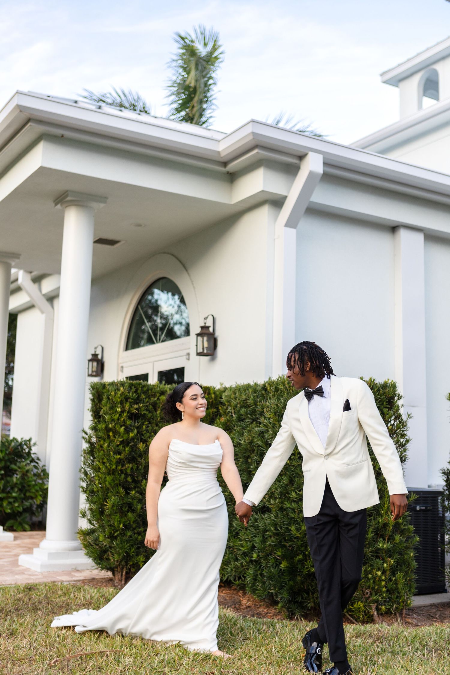 International bride and groom walking at Harborside Chapel in Safety Harbor, Florida — wedding photographer Grand Photo, Karyna Oliinyk