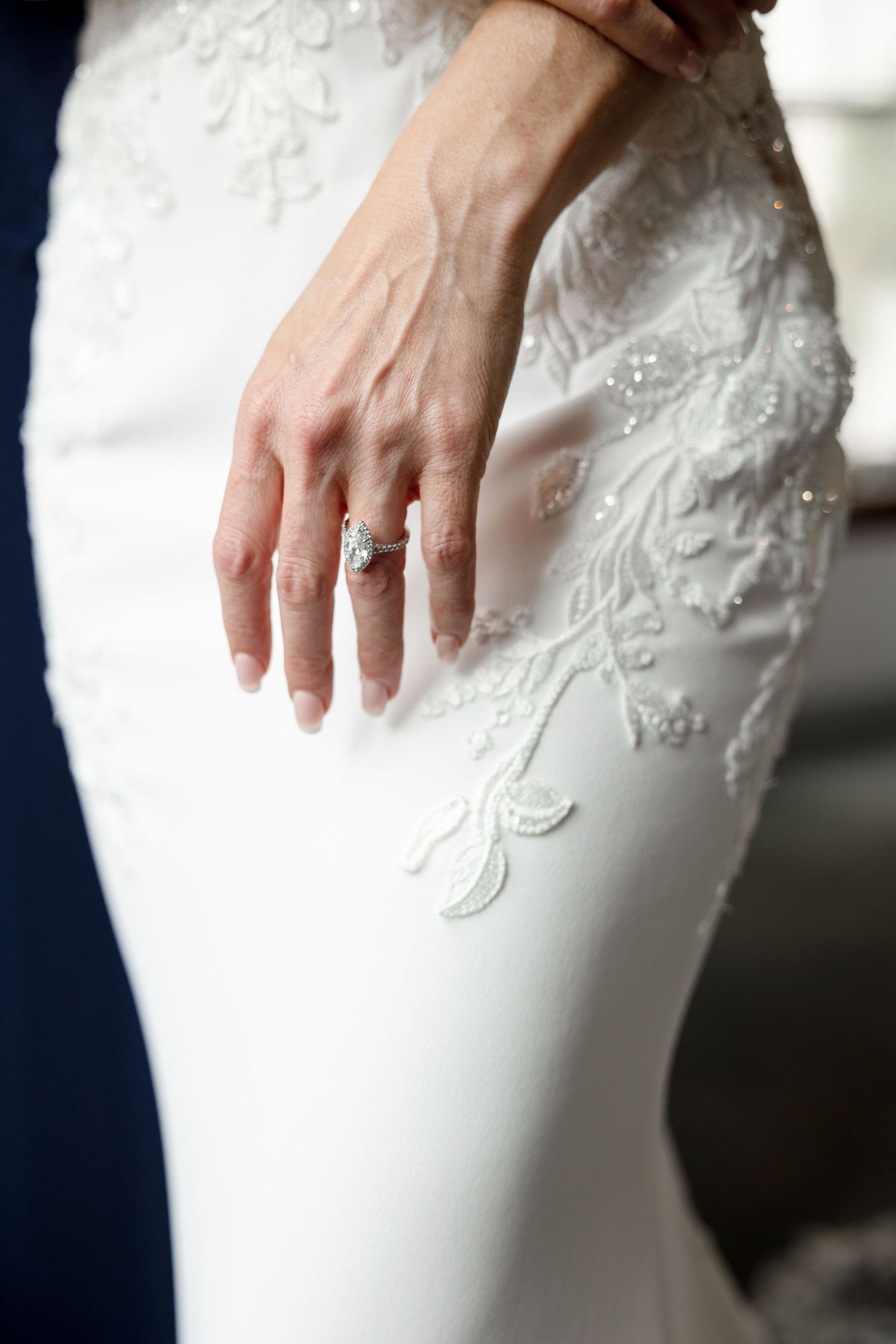Close-up of a bride's hand with a diamond engagement ring at Le Méridien Tampa, Florida, captured by Grand Photo by Karyna Oliinyk