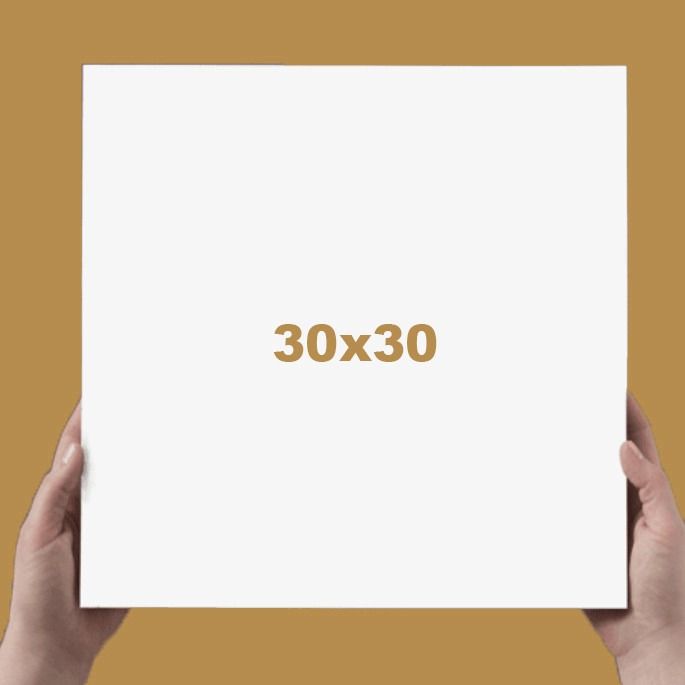 Hands holding a 30x30 white square canvas against a golden brown background.