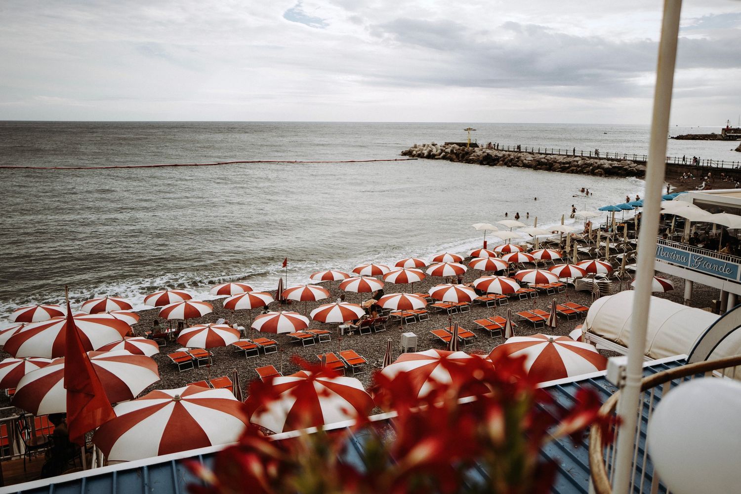 Amalfi coast with red and white umbrellas.