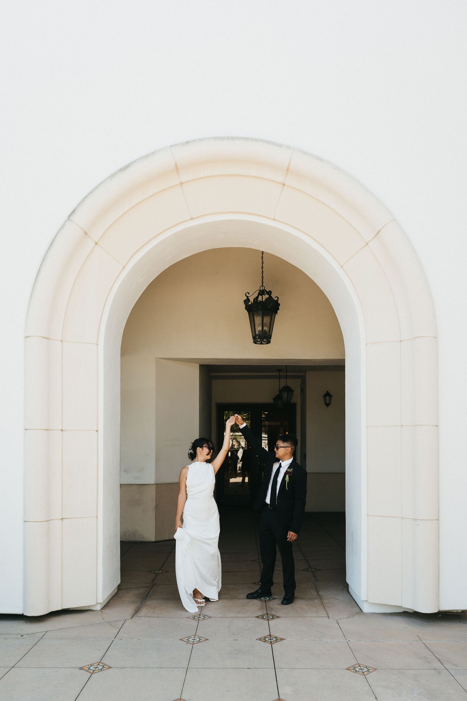 Newlyweds dancing outside of Laguna Hills Civic Center on their elopement day.
