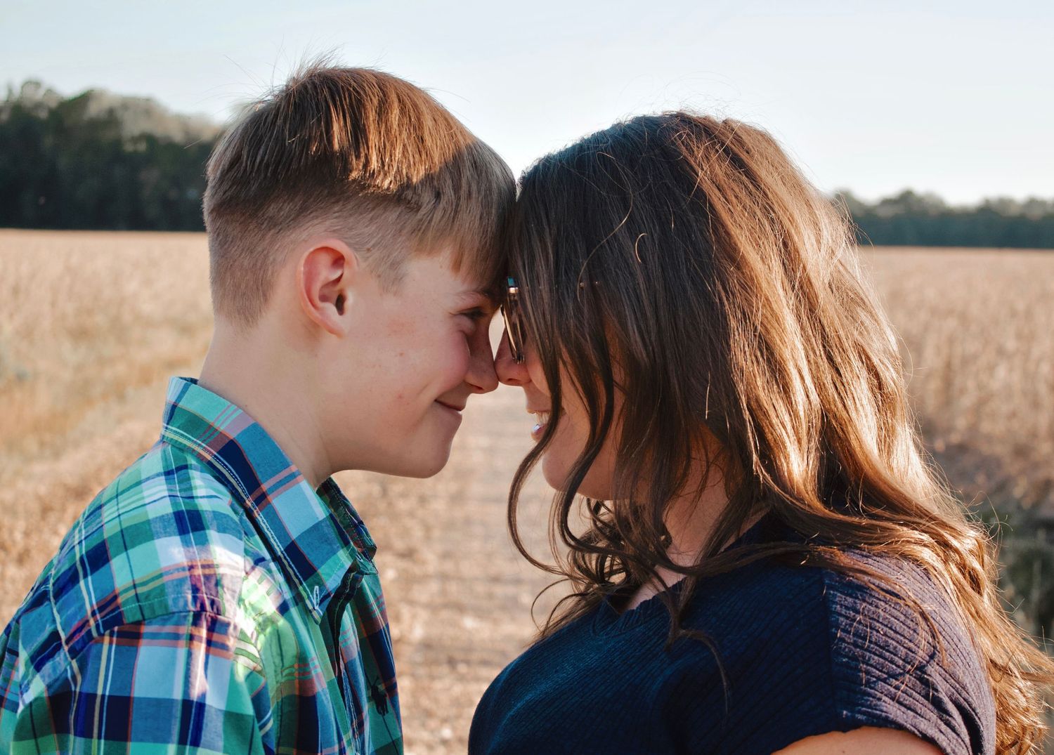 Mother and son sharing a laugh on a dirt road.