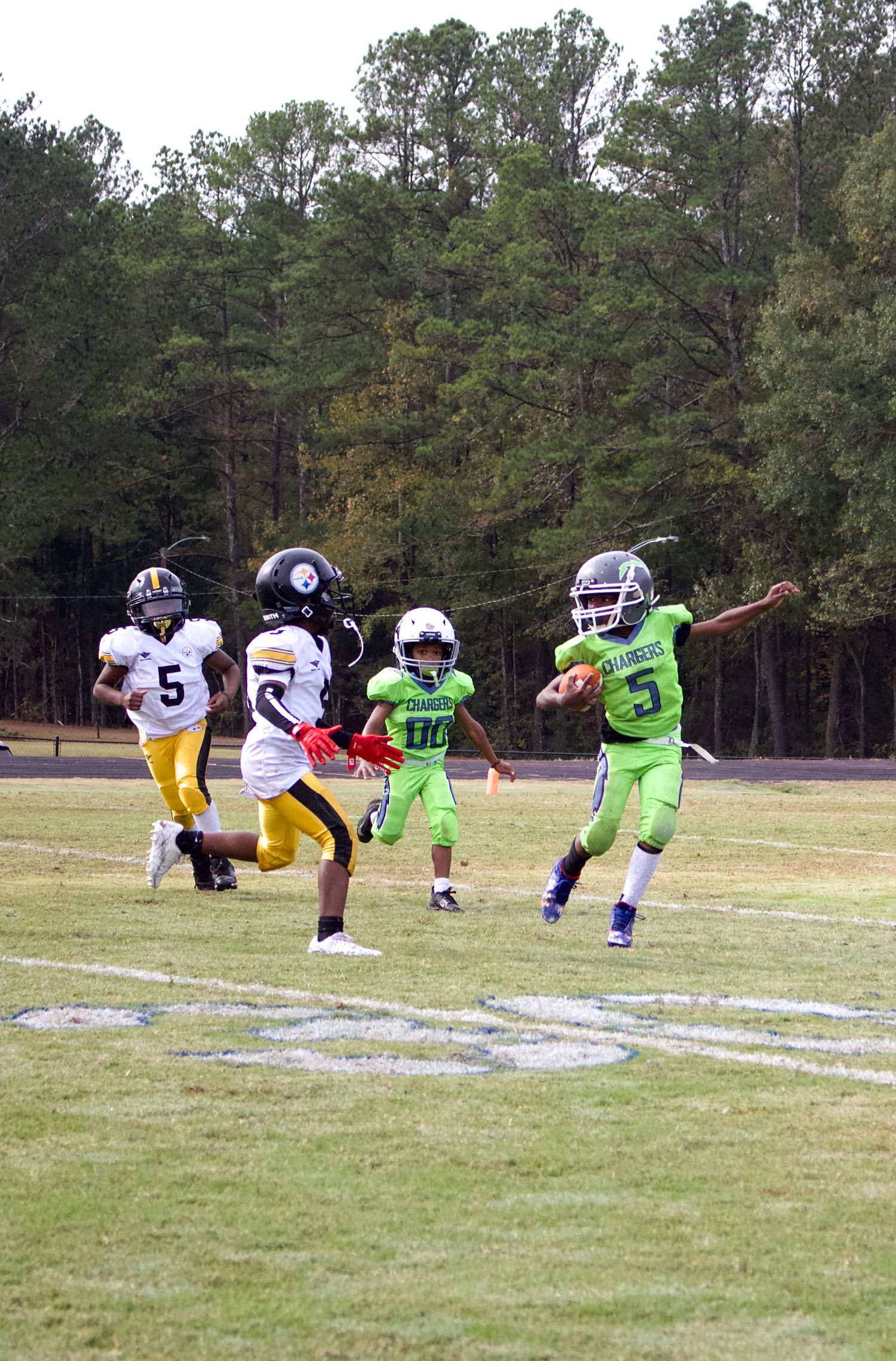 Little league player showing off their jump skill to avoid contact.