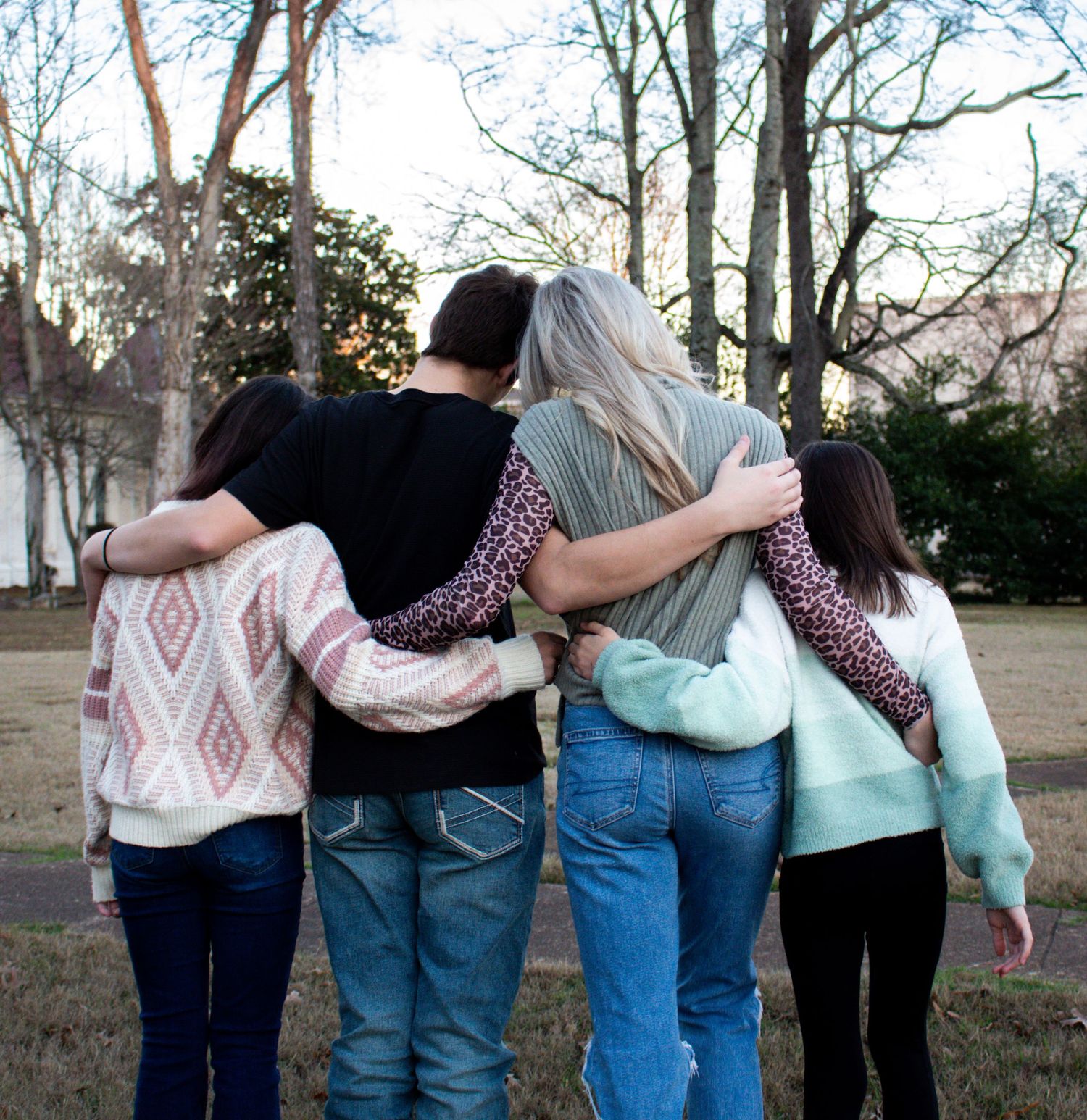 Siblings wrapped in embrace.