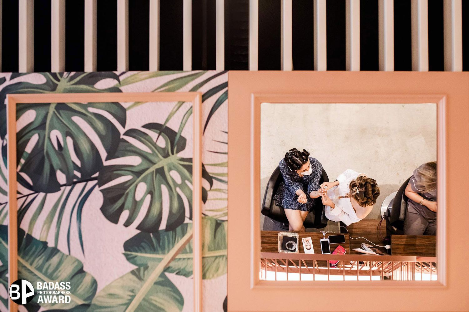 Badass Award-winning creative mirror reflection of a bride and bridesmaid getting ready against tropical wallpaper in Istanbul.