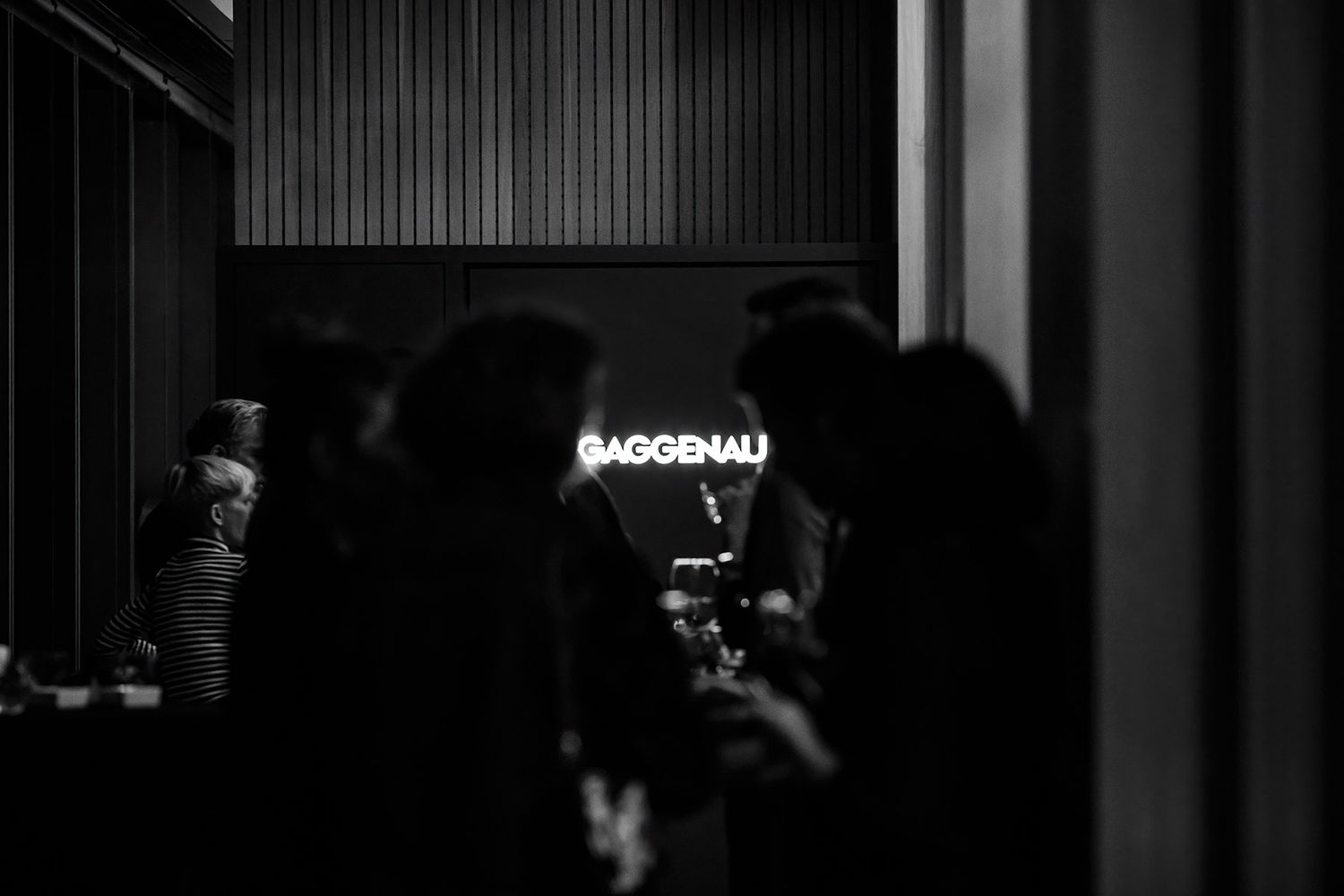 A moody, black and white documentary shot of guests networking at a Gaggenau brand activation event in Istanbul.