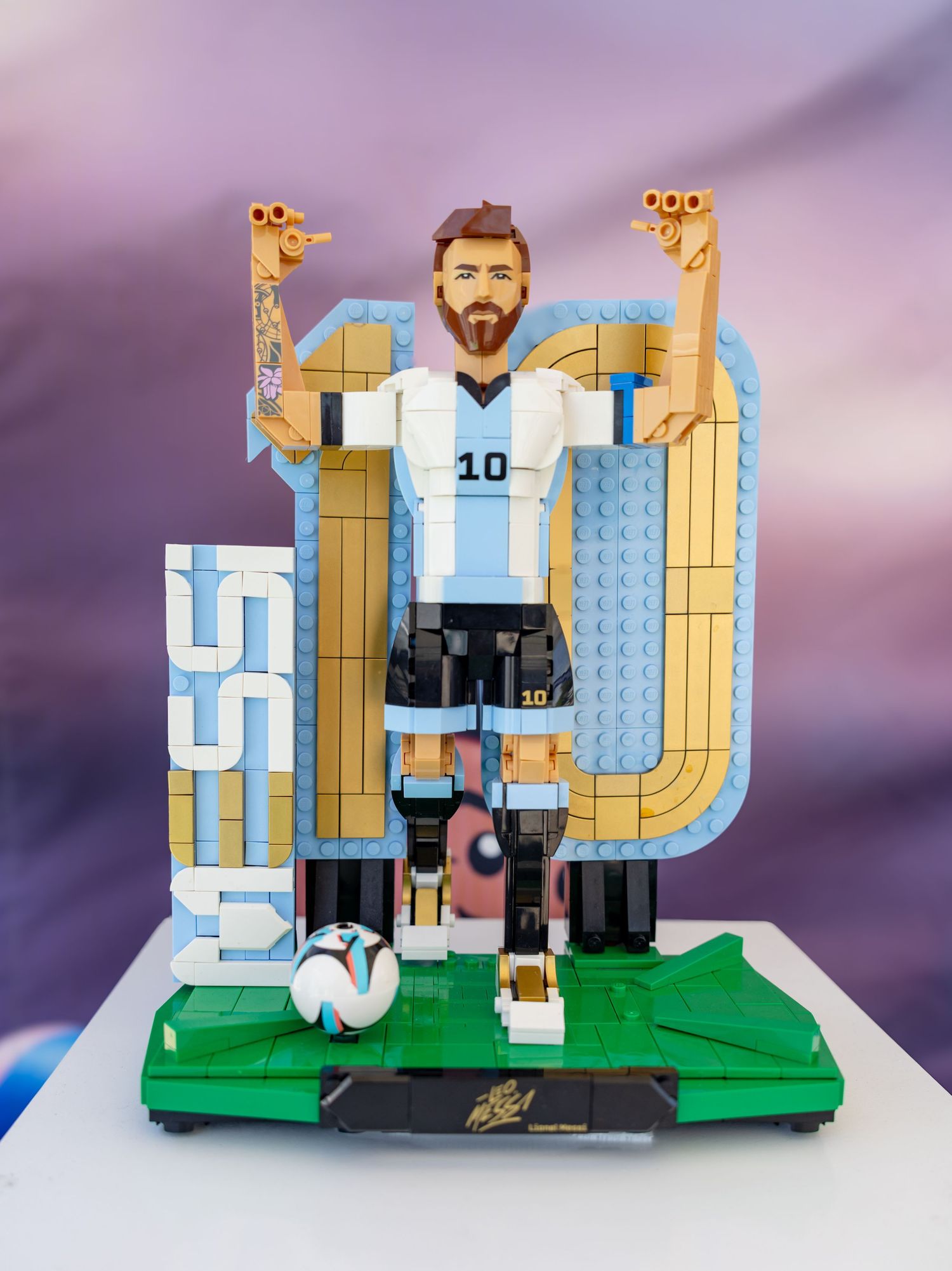 Detailed LEGO brick sculpture of soccer player Lionel Messi wearing Argentina number 10 jersey.