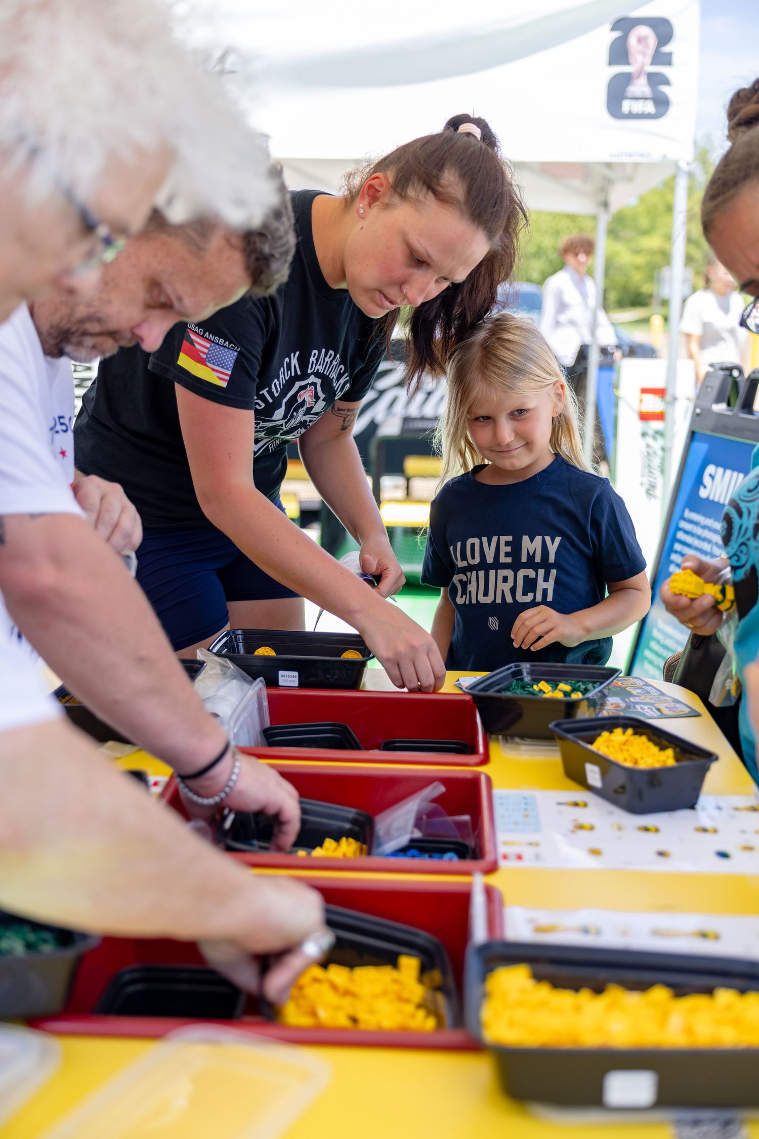 Families engage together at a LEGO brand activation experience during a corporate event in Dallas, highlighting interactive product