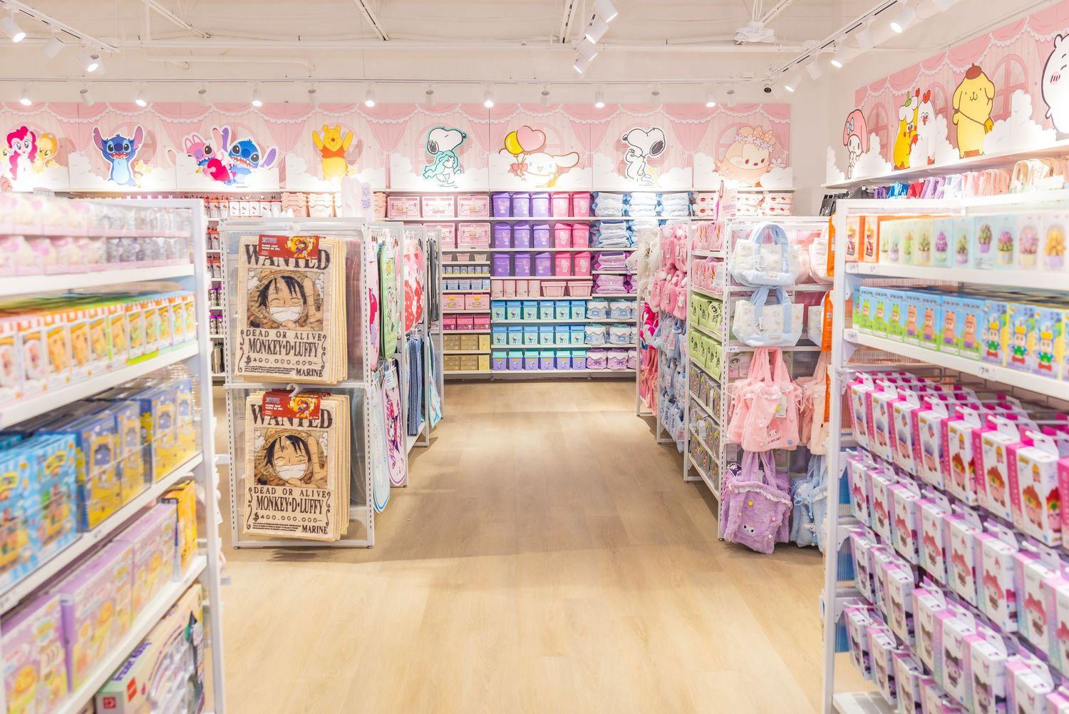 Wide aisle of a MINISO store lined with colorful packaged products on white shelves under bright lighting.