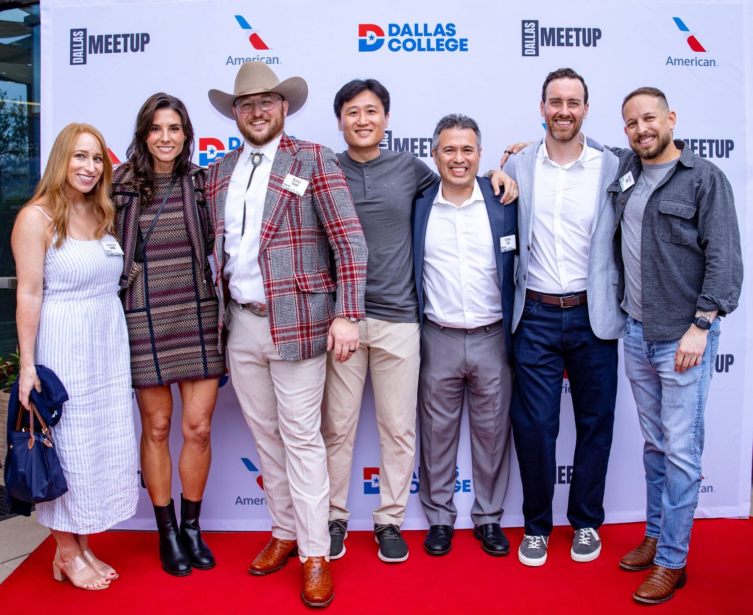 Group of professionals posing on a red carpet at the Dallas Meet-Up event.